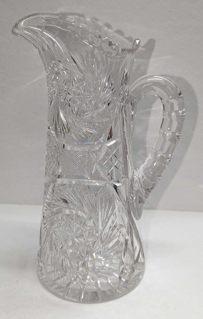 Vintage Cut Glass Stars & Fans 10" Pitcher: Vintage Cut Glass Stars & Fans 10" Pitcher. This is approx 6" x 5" x 10" and it weighs 4.33 lbs. The pitcher has no chips or cracks. The maker and date of creation are unknown.
