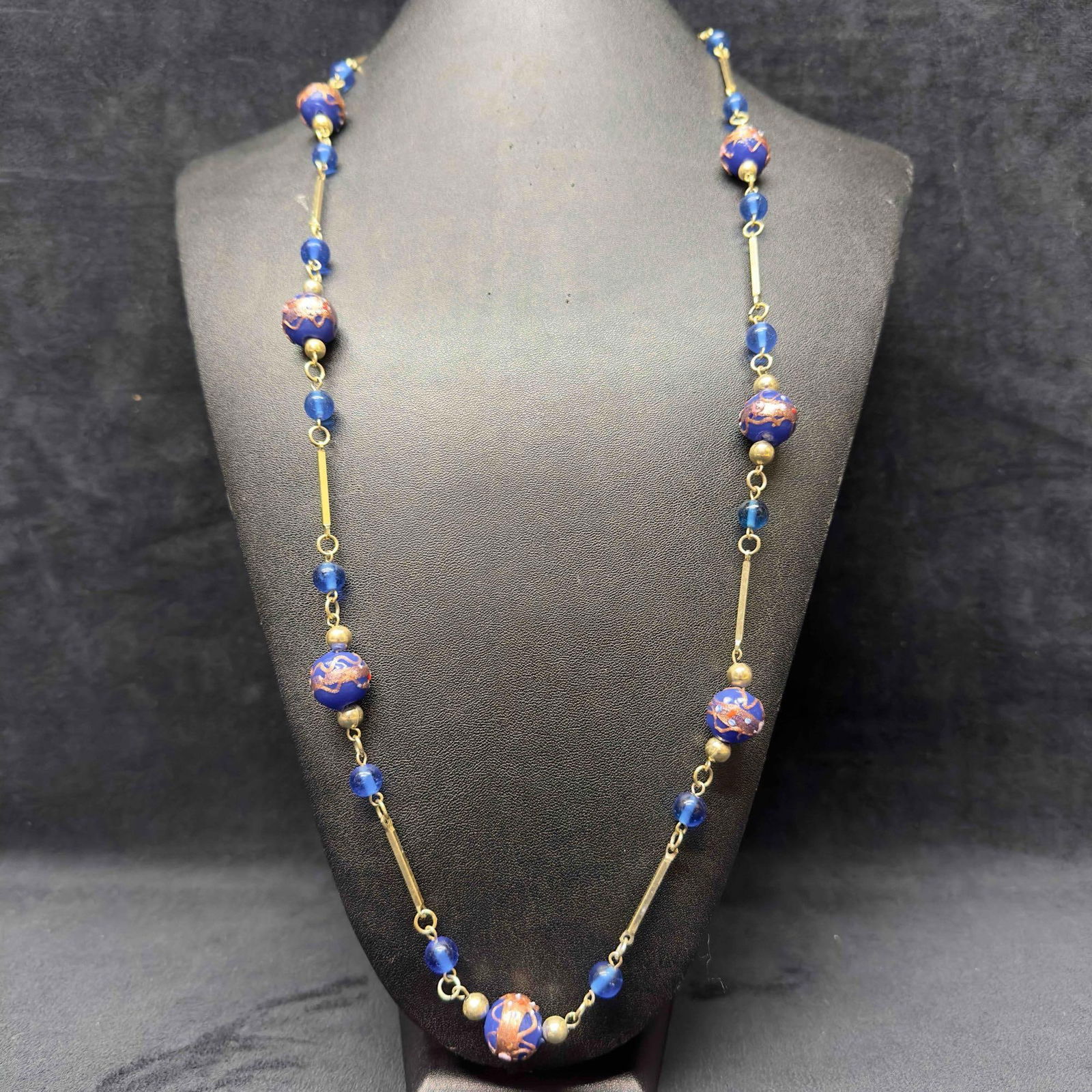 Murano Venetian Art Glass Lamp Work Bead Blue Beaded Silver Toned Chain Long Necklace C16: Murano Venetian Art Glass Lamp Work Bead Blue Beaded Silver Toned Chain Long Necklace C16. Necklace with blue colored glass beads with beautiful designs on each. The necklace features silver toned