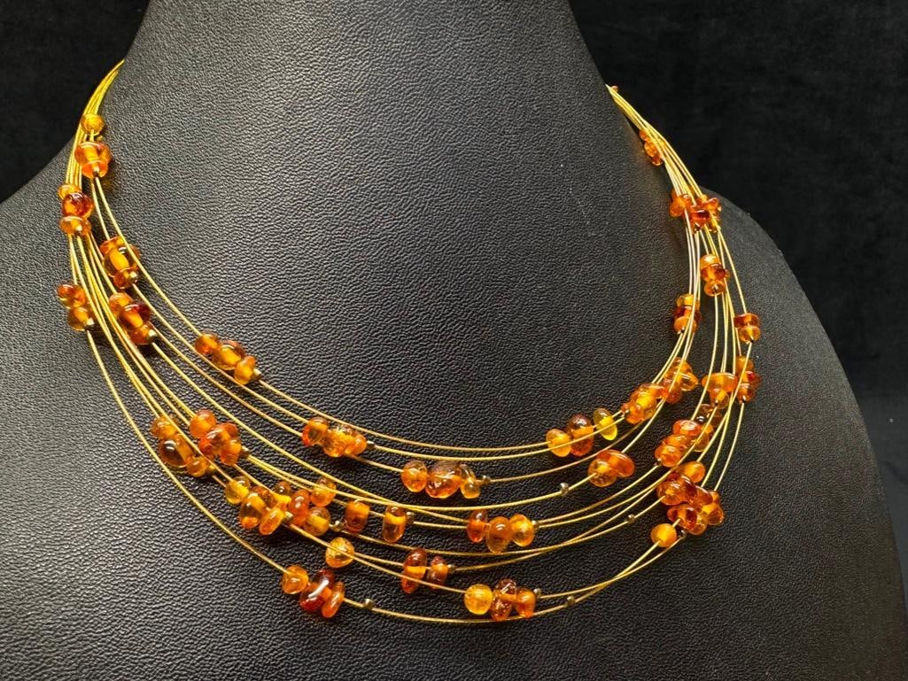 Multi-Strand Amber Bead Wire Necklace: This piece of jewelry has been tested and researched prior to listing. Please view all our pictures they are part of our description. DETAILS: Metal - base metal Color - gold Stones - Amber Hallmarks