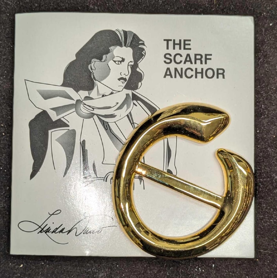 Linda Dano Gold Tone Scarf Anchor Brooch: Linda Dano Gold Tone Scarf Anchor Brooch. It comes with the original card that is approx 4 1/4" x 1/4" x 4 1/4" and it weighs 0.10lb. 