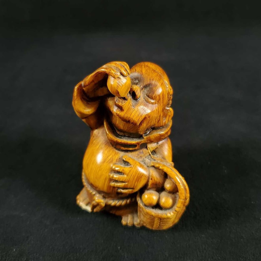 Handmade Ceramic Drinking Old Monk: This ceramic drinking old Monk priest has a basket in hand and is handmade/ hand painted. 19th Century. Unmarked; unknown artist. In good condition with a small chip on his toes. Measures approx 2