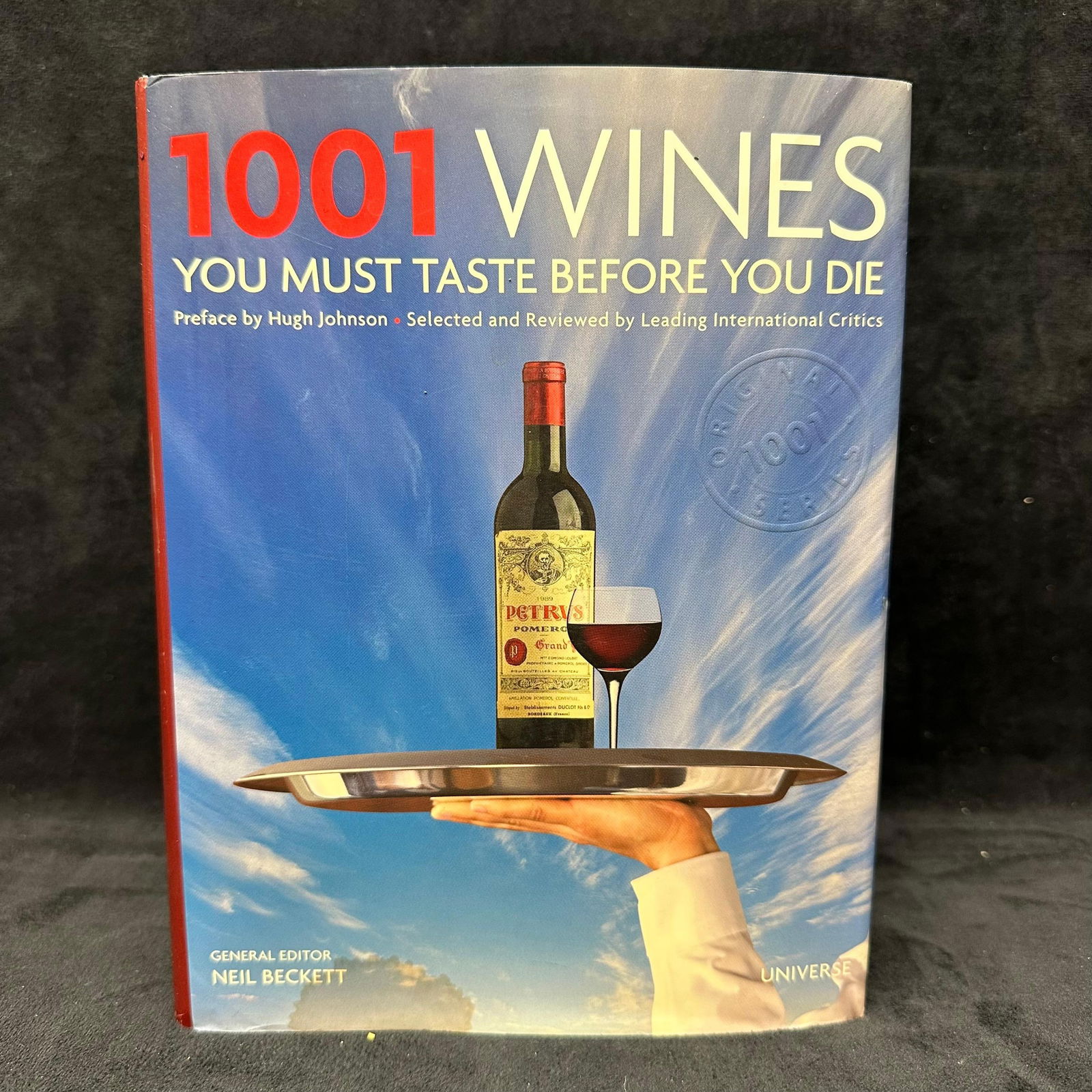 1001 Wines You Must Taste Before You Die by Neil Beckett Hardcover Table Book: Hardcover reference guide featuring 1,001 notable wines from around the world. Edited by Neil Beckett with selections reviewed by leading international critics. Includes tasting notes, wine history,