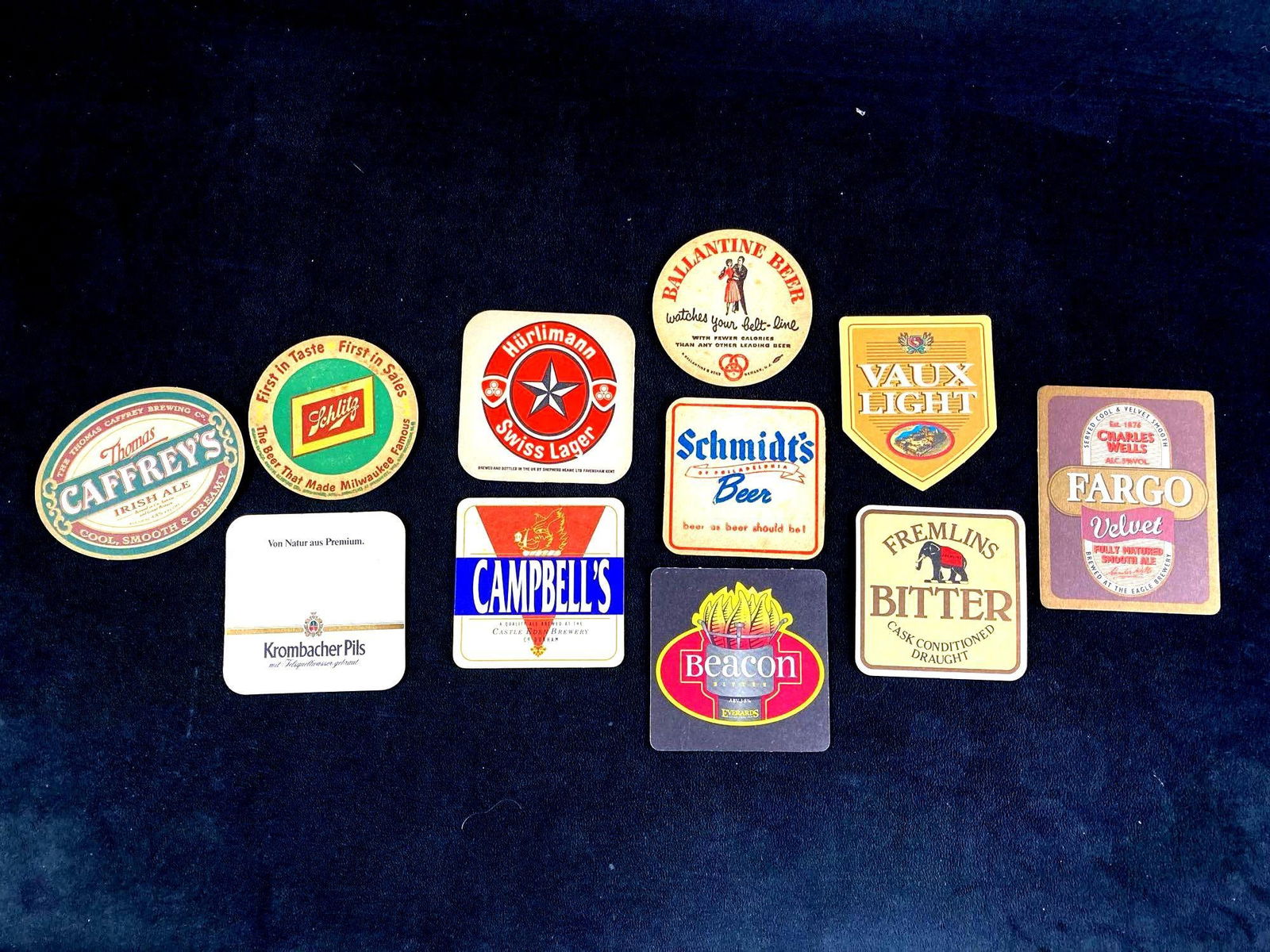 Set of (11) Beer Coasters Label Variety: This auction includes: (11) Vintage Beer Coasters Beacon Bitter, Campbell's, Fargo Velvet, Fremlin's, Caffrey's, and more. Condition is used and refer to photographs for additional