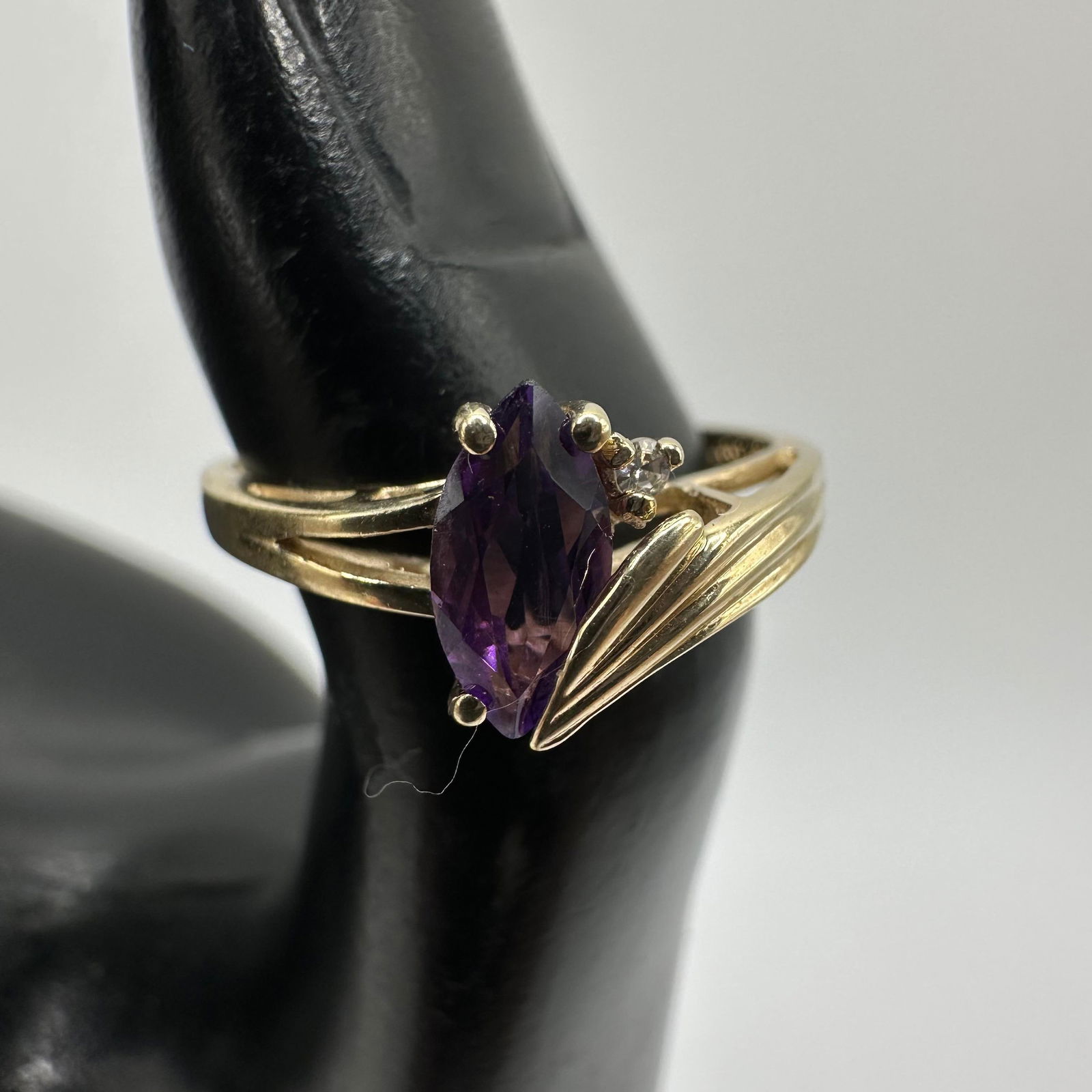 10K Gold Ring Marquise Cut Amethyst Round Accent Diamond: This item is in good pre-owned, previously used/displayed condition with noticeable light wear and surface scratches. Please reference all photos for full details. This piece of jewelry has been