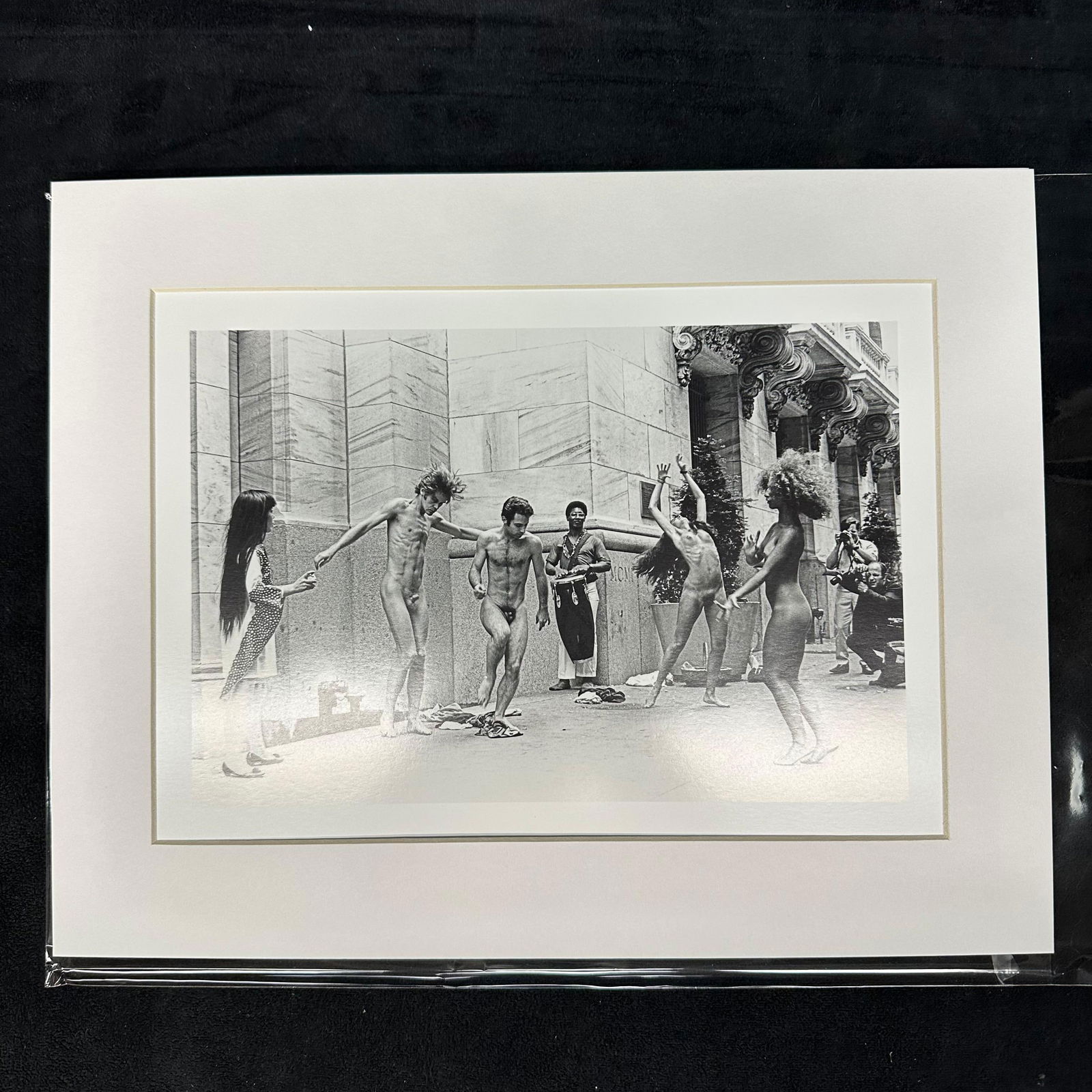 Yayoi Kusama Body Festival Black and White Photo Print Matted: Black and white photographic print depicting Yayoi Kusama’s nude performance happening (Body Festival) outside a New York City building, circa late 1960s. The image shows dancers and onlookers