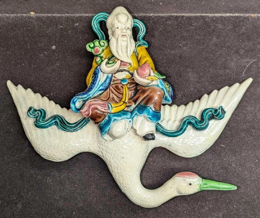 Vintage Ceramic God Of Longevity Shouxing On The Swan Wall Figurine: Vintage Ceramic God Of Longevity Shouxing On The Swan Wall Figurine.The maker and date of creation is unknown. Has a crackle texture. This is approx 13" x 4" x 9 1/2" and it weighs 1.50lb. The