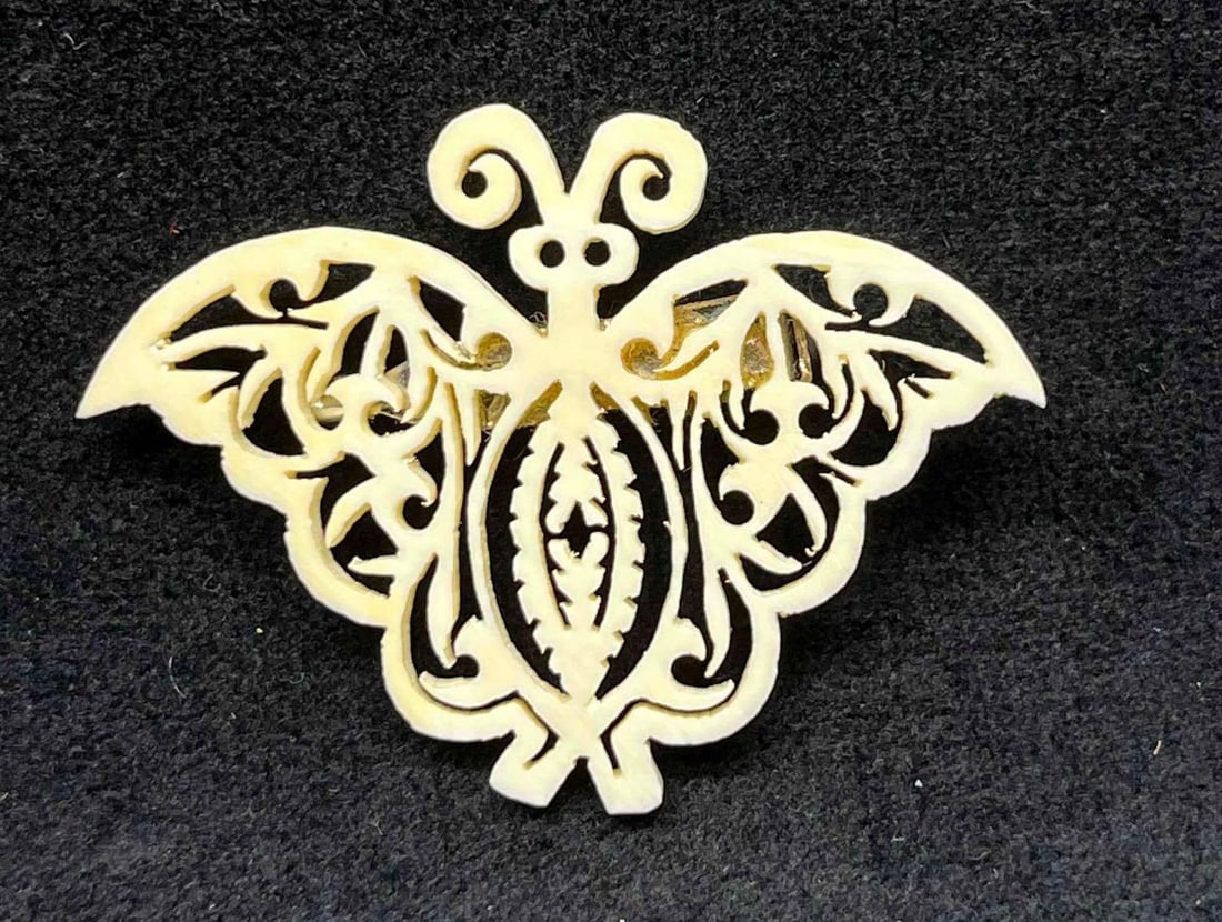 Hand Carved Bone Butterfly Brooch: This lot contains a Hand Carved Bone Butterfly Brooch. The brooch is approx 1 1/2" x 2" x 1/2". Total weight is less than 1 gram. Overall the Hand Carved Bone Butterfly brooch is in excellent pre