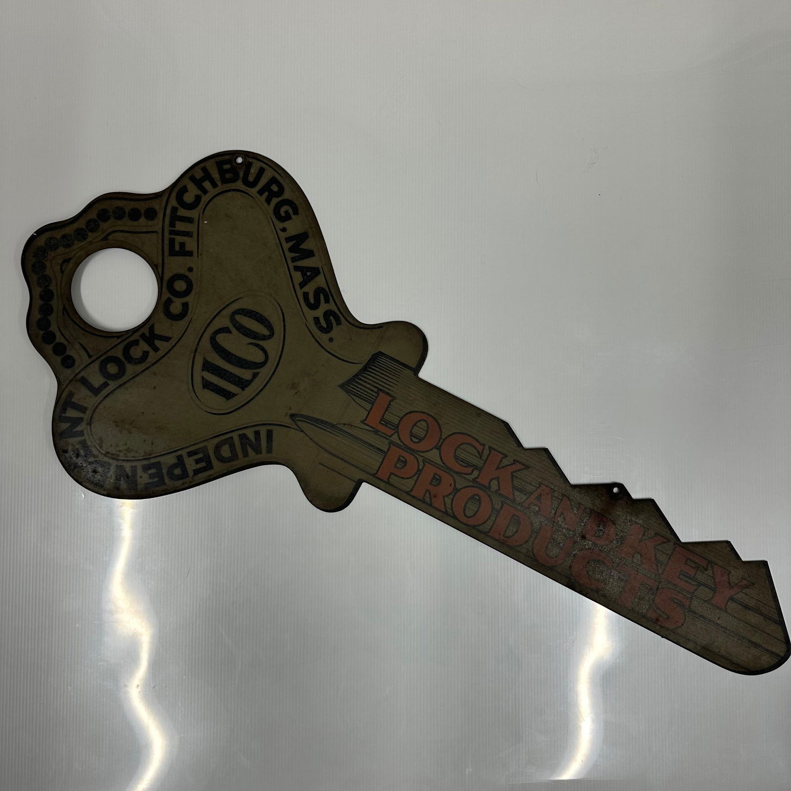ILCO Hardware Store Lock And Key Products Tin Litho Sign: Vintage die-cut litho tin advertising sign in the form of a large key for Independent Lock Co., Fitchburg, Massachusetts. The sign features bold printed graphics, including the ILCO and the slogan