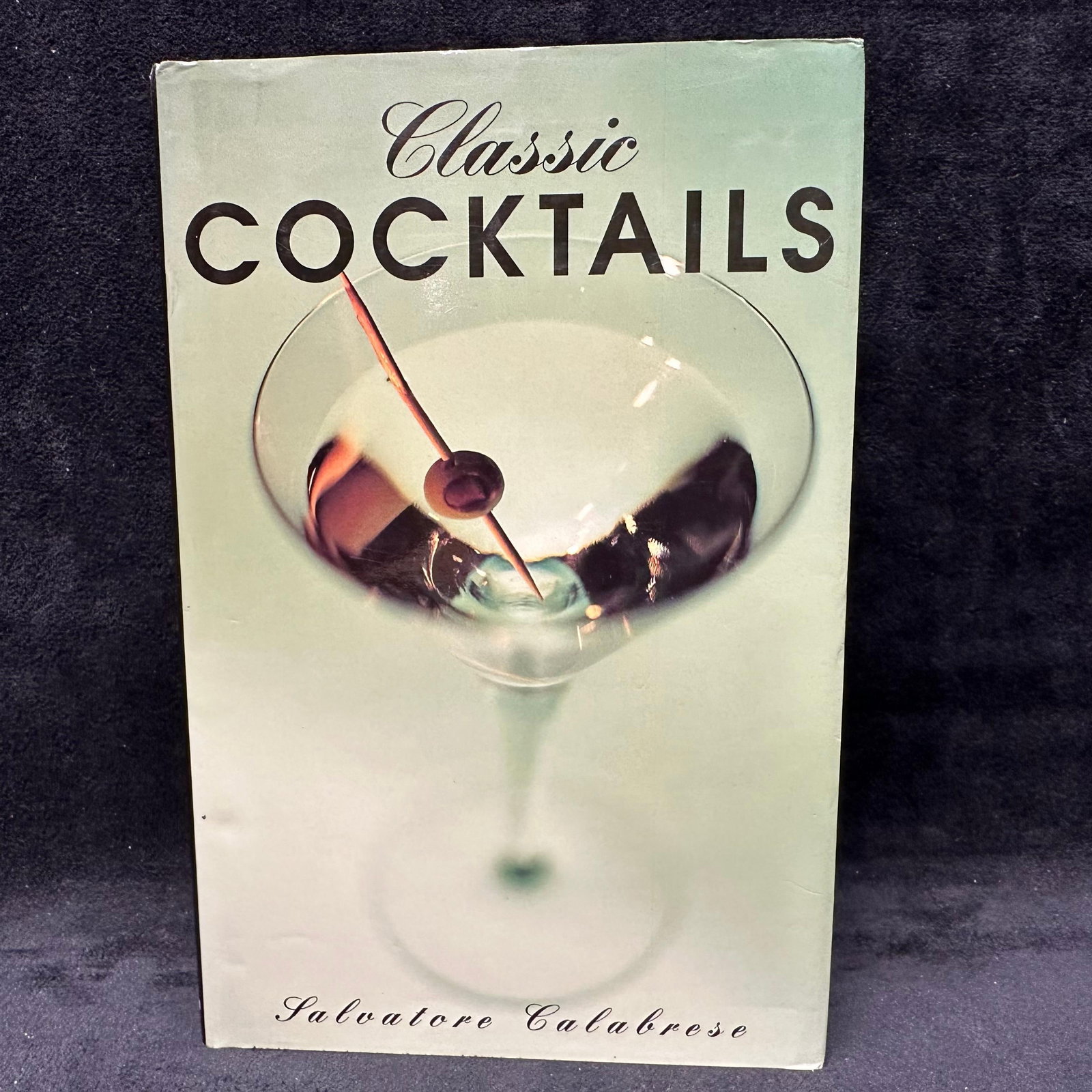 Signed Copy of Classic Cocktails by Salvatore Calabrese with Handwritten Dedication and Ephemera: Hardcover copy of Classic Cocktails by renowned bartender and author Salvatore Calabrese. The book is signed and inscribed on the title page with a handwritten dedication dated 1997, including additio