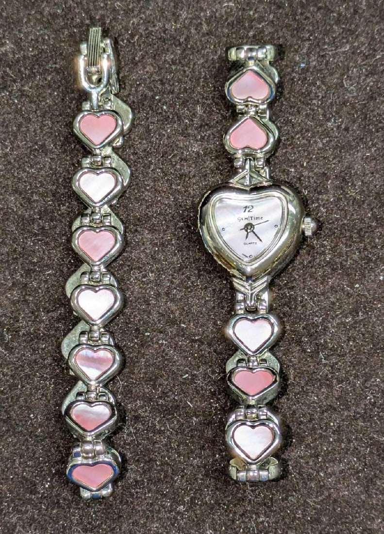 Gem Time Silvertone Heart Watch And Bracelet: Gem Time Silvertone Heart Watch And Bracelet. The watch has a stainless steel back and is approx 8". The bracelet is 8". The watch requires a new battery. Both come in a bag that is approx 3" x