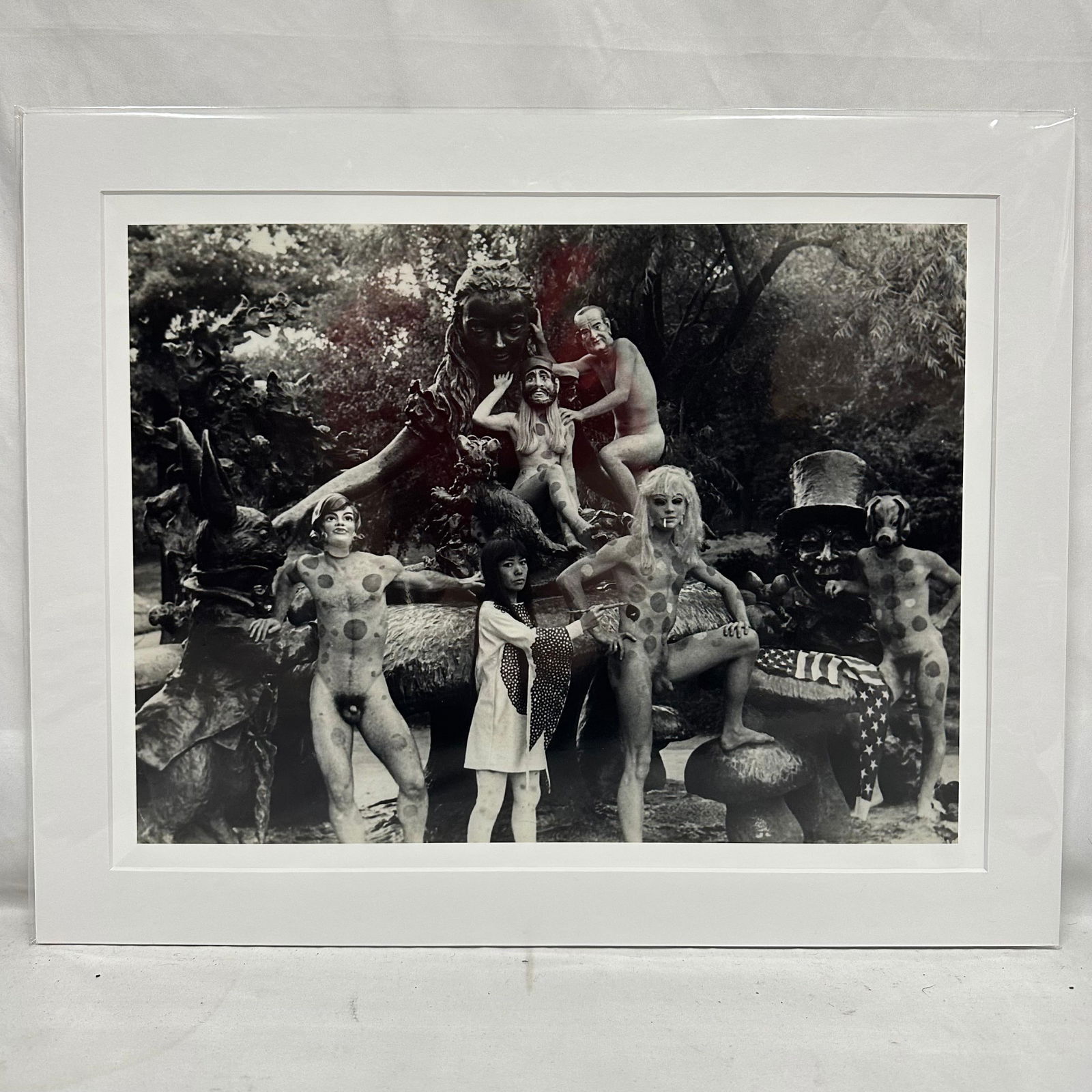 Yayoi Kusama Black and White Photo Print Central Park NY Nude Matte: Medium Black and white photographic print depicting Yayoi Kusama posed with polka-dotted nude models in an outdoor sculptural statue, Alice in Wonderland, setting in New York's Central Park. Print