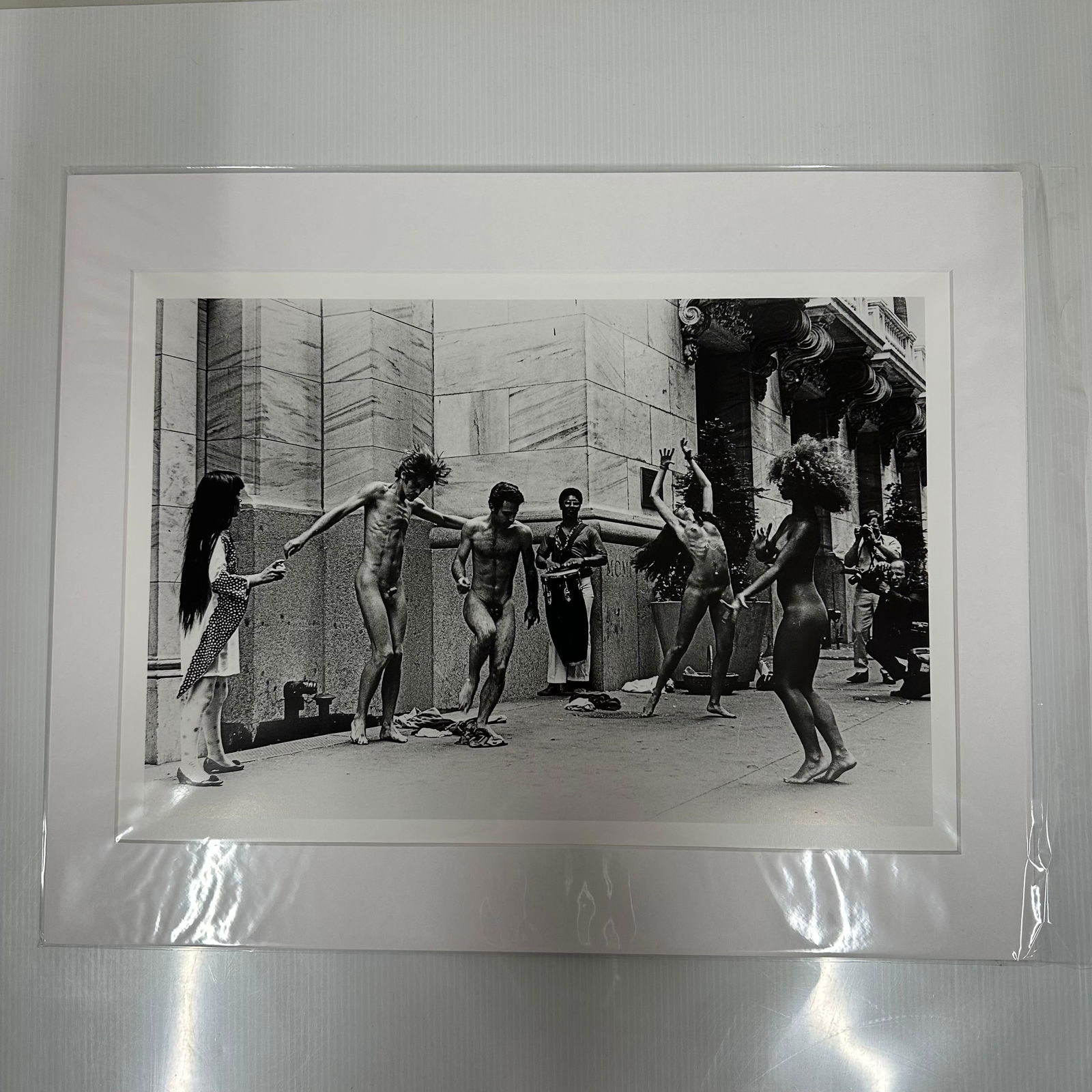 Yayoi Kusama Body Festival Black and White Nude Photo Print Medium Matted: Medium Black and white photographic print depicting Yayoi Kusama’s nude performance happening (Body Festival) outside a New York City building, circa late 1960s. The image shows dancers and onlooker