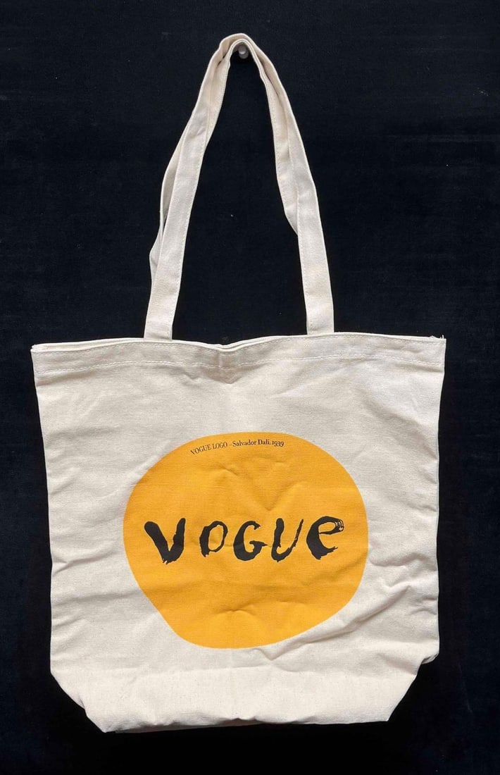Vogue Limited Edition Canvas Tote Bag Salvador Dali 1939 Logo: This lot contains a Vogue Limited Edition Canvas Tote Bag Salvador Dali 1939 Logo. It is approx 15" x 15" x 1/2" when flat and it weighs about 0.3lbs. With the straps its approx 25" long. Overall the