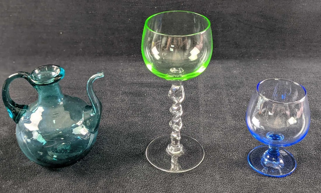 Twisted Stem Aperitif Glasse Blue Glass Cordial & Mini Pitcher: This lot includes: (1) Twisted Stem Green Vaseline Glass Top Aperitif Glass. Is approx 2 1/2" x 2 1/2" x 6".(1) Blue Glass Cordial Glass.Is approx 2 1/2" x 2 1/2" x 3 1/2".(1)