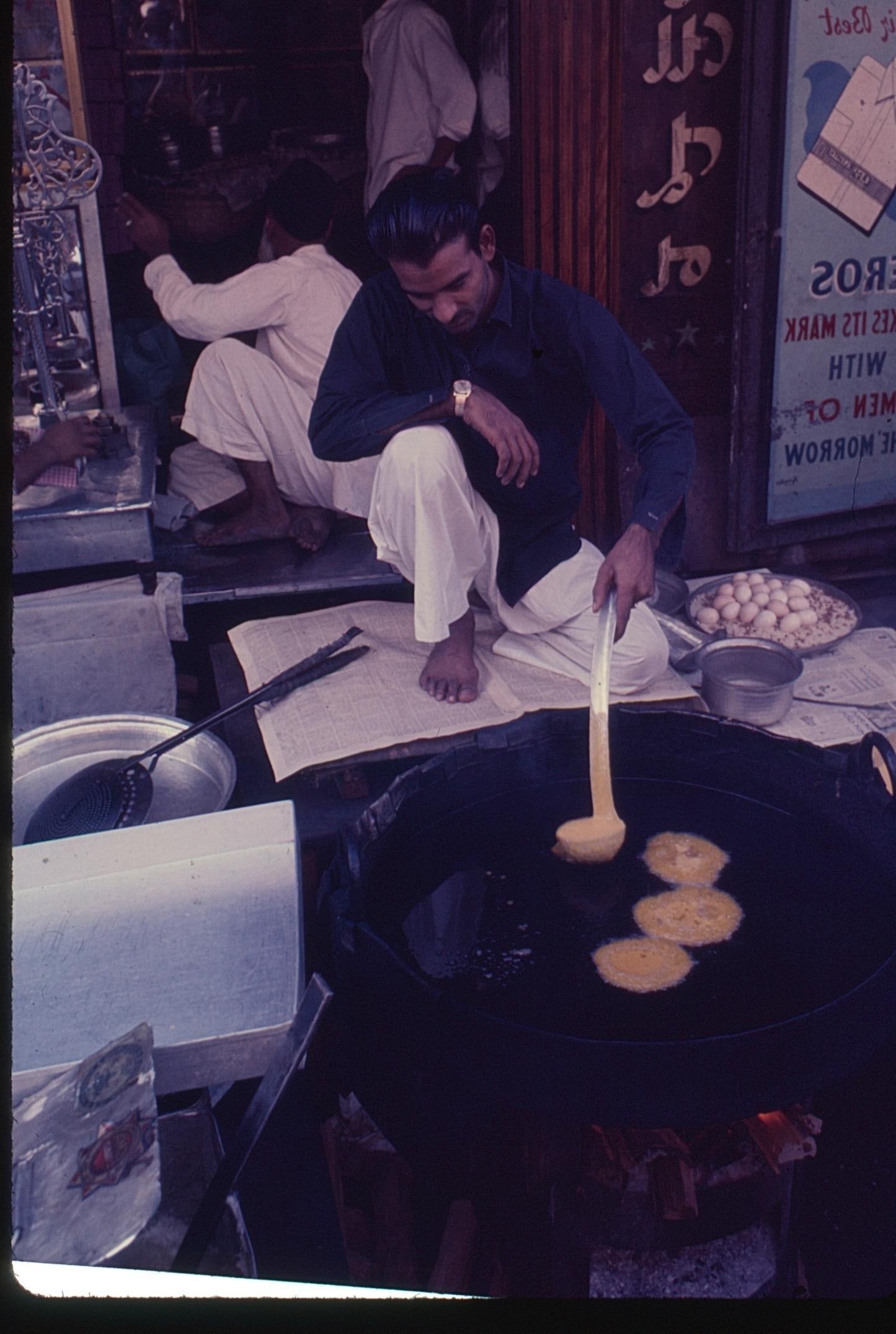 Vintage Digital Print Set with Original 35mm Slide Street Vendor Frying Food: Color digital print set showing a street vendor preparing fried foods at an outdoor market, accompanied by the original 35mm photo slide mounted for preservation. Vivid imagery captures authentic