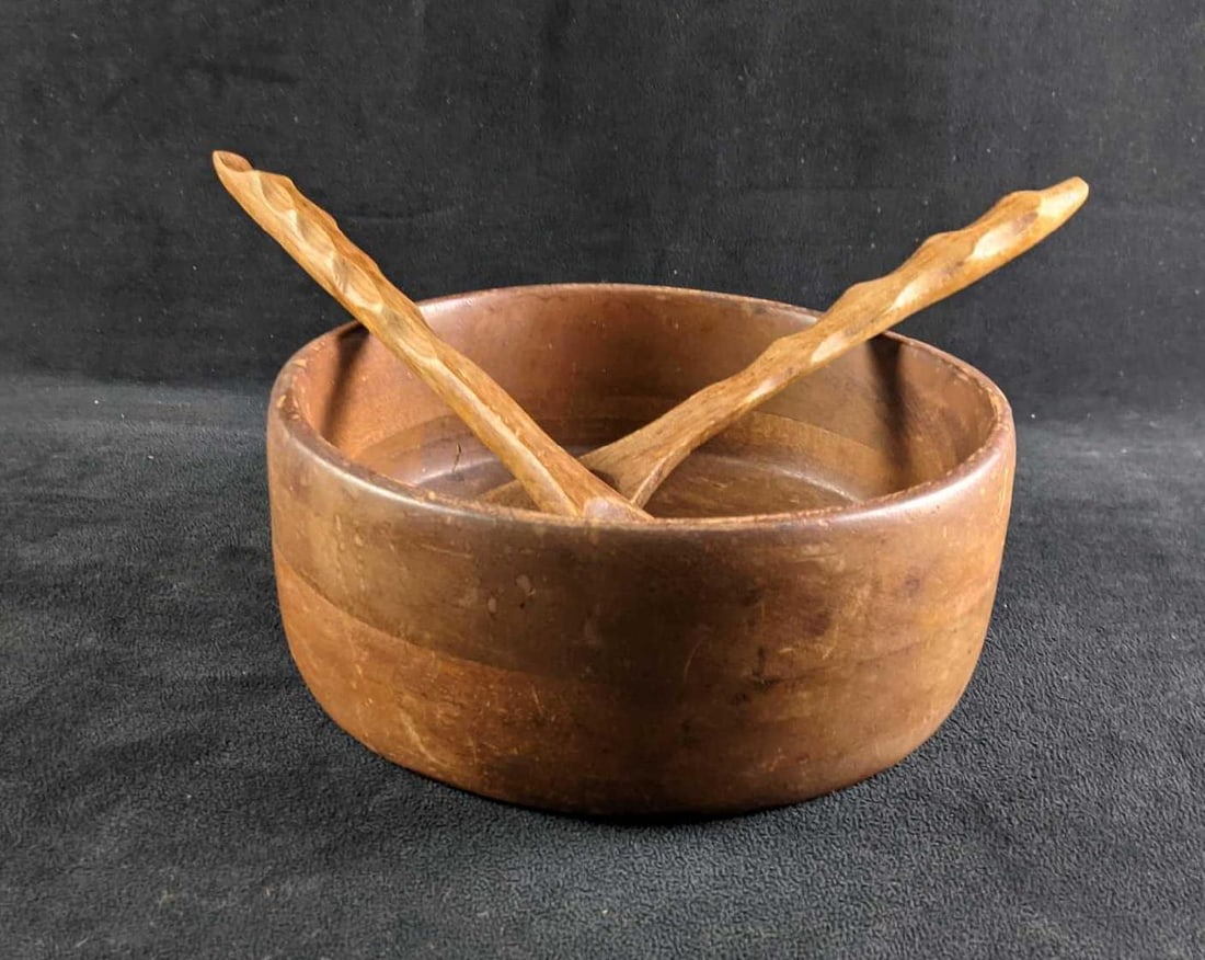 Wooden Salad Bowl Set: Wooden Salad Bowl Set This is a wooden salad bowl set that comes with three pieces. It comes with a bowl, a salad mixing fork, and a salad mixing spoon. The bowl has some wear such as scratches and