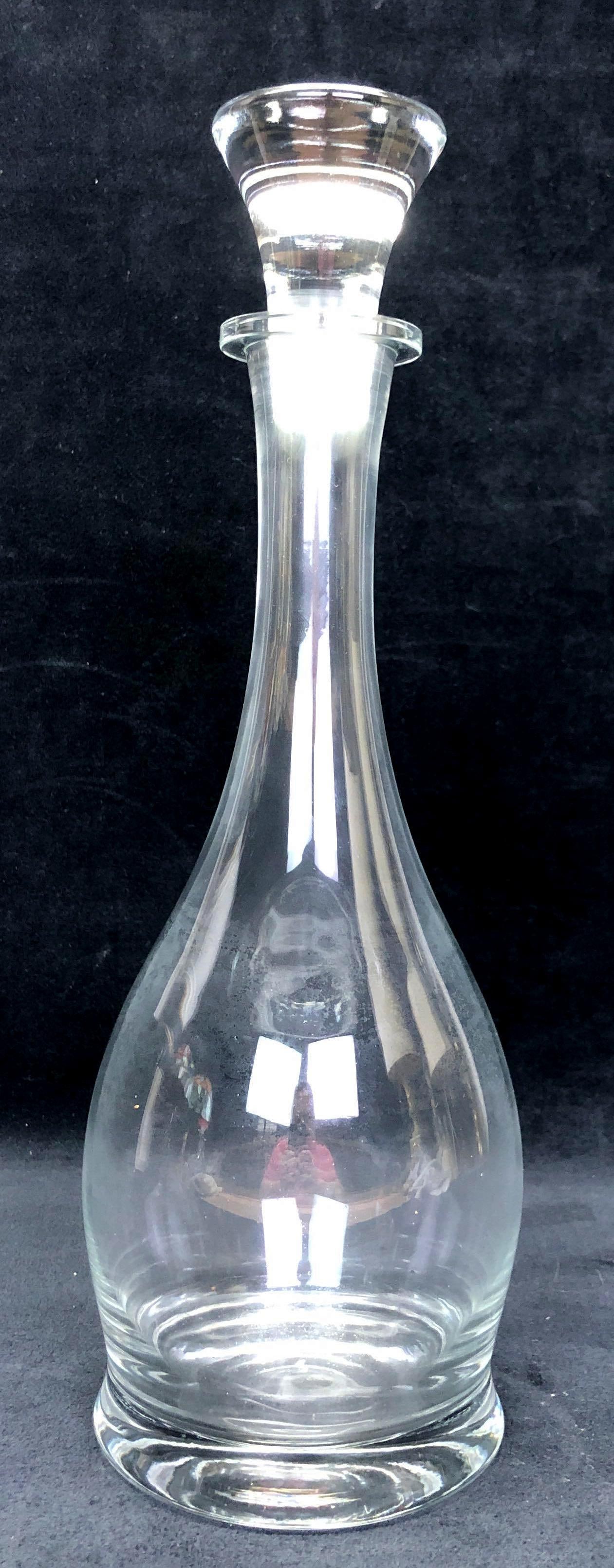 Vintage MCM Clear Glass Wine Decanter with Stopper: Vintage MCM Clear Glass Decanter with Stopper. The Vintage Decanter is approximately 14-1/2" x 5-1/2" x 5-1/2" and weighs about 2.0lbs. Overall the item is in vintage condition with signs of wear and