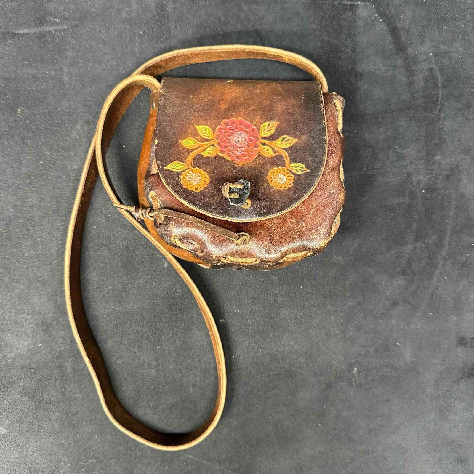 Handcrafted Leather Mini Purse with Floral Design Cathy Uddo: Vintage handcrafted leather mini purse featuring a hand-painted floral design on the flap and rustic leather stitching around the edges. The interior flap is inscribed Cathy Uddo, likely the artisan