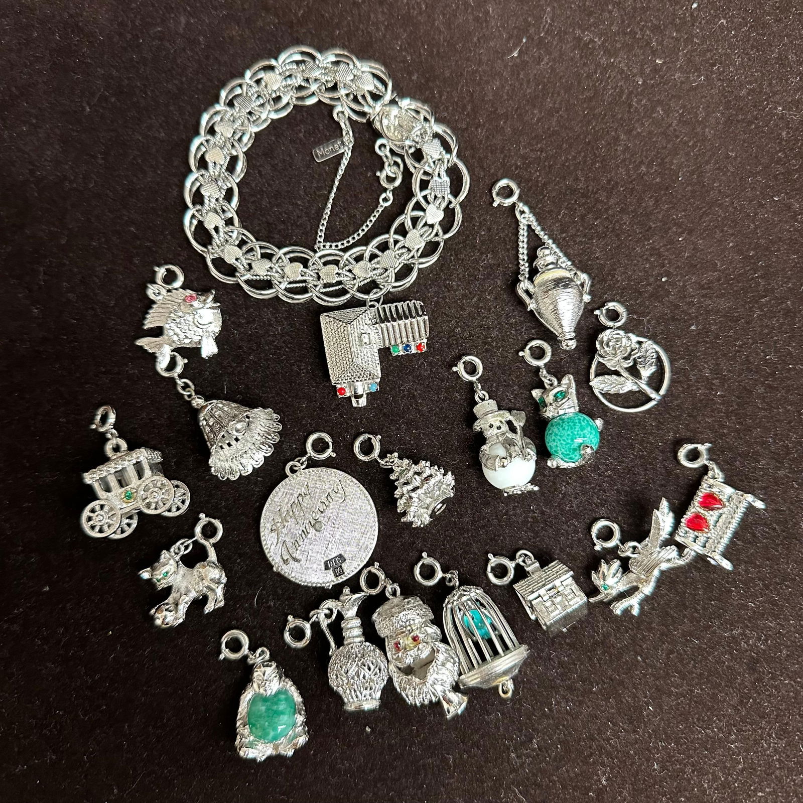 Vintage Silver Tone Monet House Charm Bracelet with 17 Interchangeable Charms: Vintage Monet silver-tone charm bracelet with safety chain and lobster clasp. Marked “Monet” on bracelet tag. Includes 17 interchangeable Monet charms plus one fixed charm attached to the bra