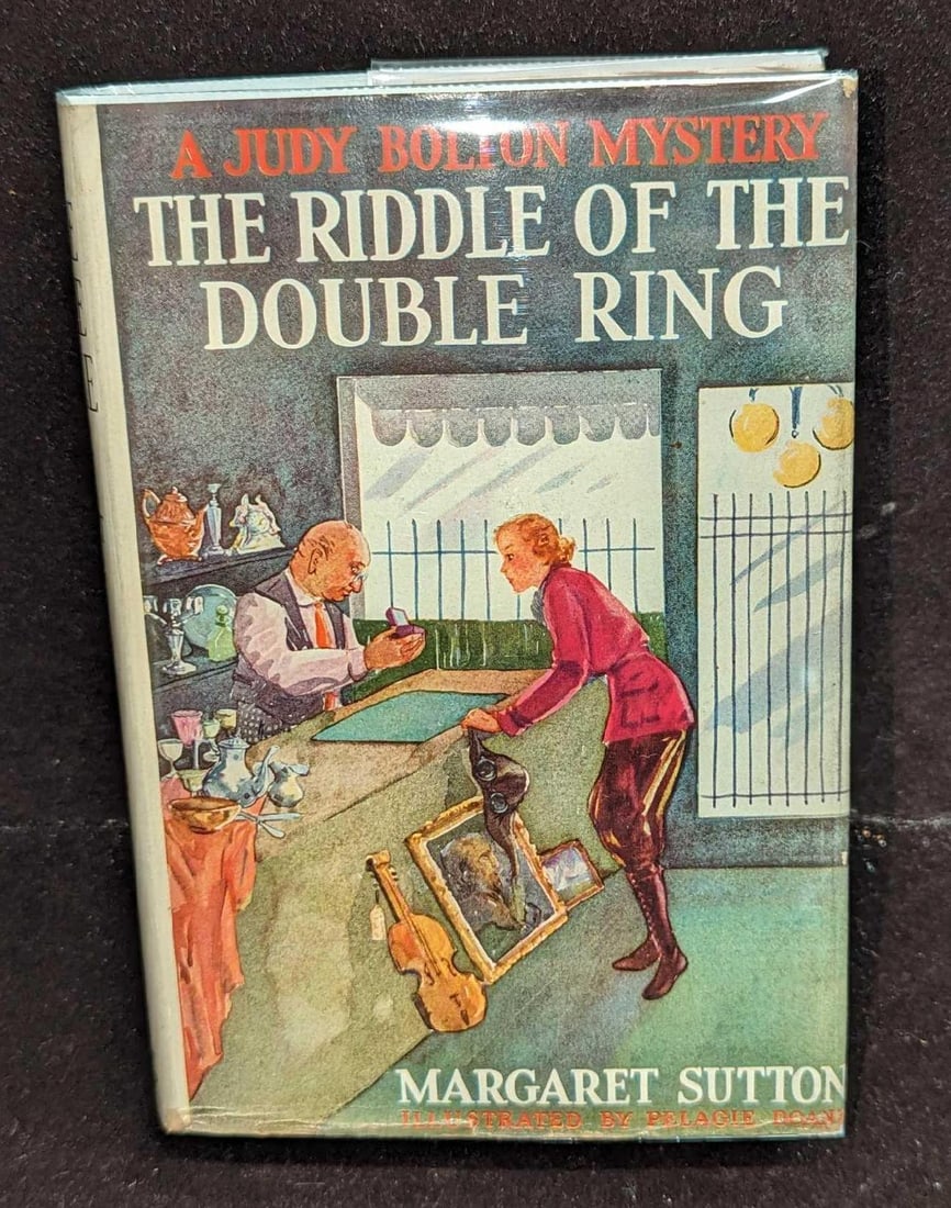 1st Ed Judy Bolton The Riddle Of The Double Ring HC #10: 1st Ed Judy Bolton The Riddle Of The Double Ring HC #10. "A Judy Bolton Mystery - The Riddle Of The Double Ring". By Margaret Sutton (The pen name of Rachel Beebe) was published by Grosset & Dunlap