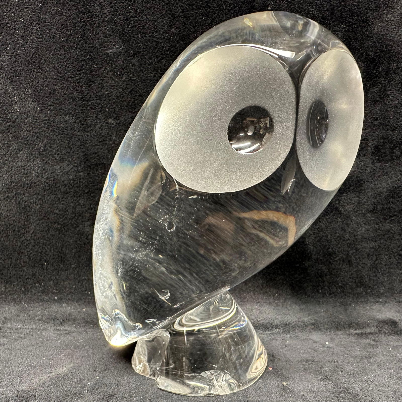 Contemporary Clear Art Glass Owl Sculpture On Pedestal Base: Solid, clear art glass owl sculpture with stylized rounded form and frosted circular eyes. The figure is mounted on an integrated pedestal base. The glass displays internal striations, light surface