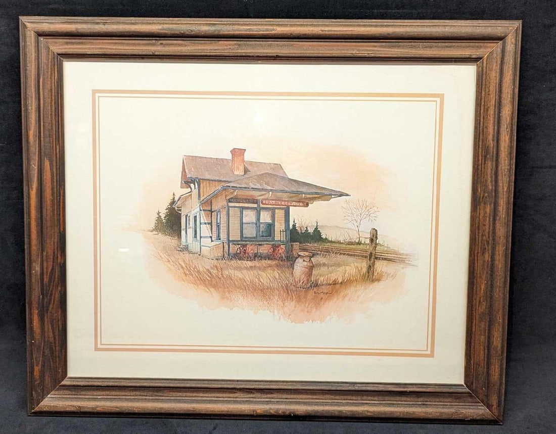 Framed Ruby Nuppin Americana Train Station Print: Framed Ruby Nuppin Americana Train Station Print. The framed print is approximately 23 1/2" x 1" x 19 1/2" and it weighs 4.55 lbs. The framed print has some chips. Please note, that the signature is