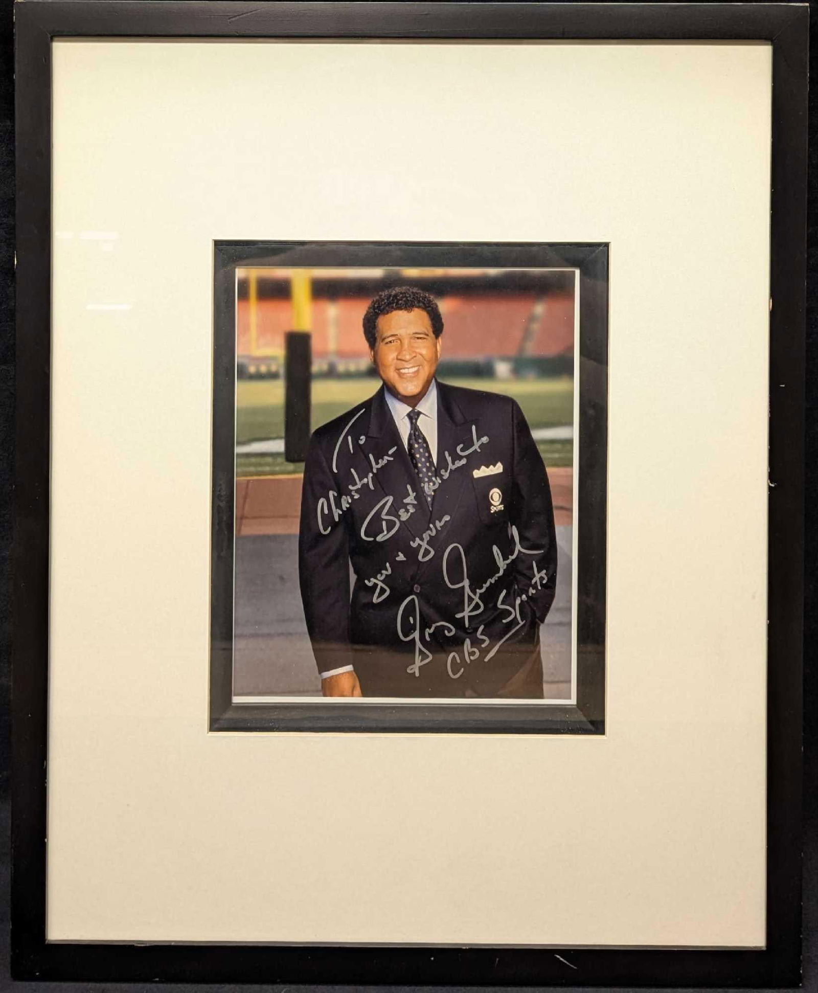 Framed CBS Sports Greg Gumbel Autographed Photo: Framed CBS Sports Greg Gumbel Autographed Photo. The framed photo is approx 21"x 17 1/4" x 3/4" and it weighs 4lbs. The frame has some chips. Please note, this does not come with