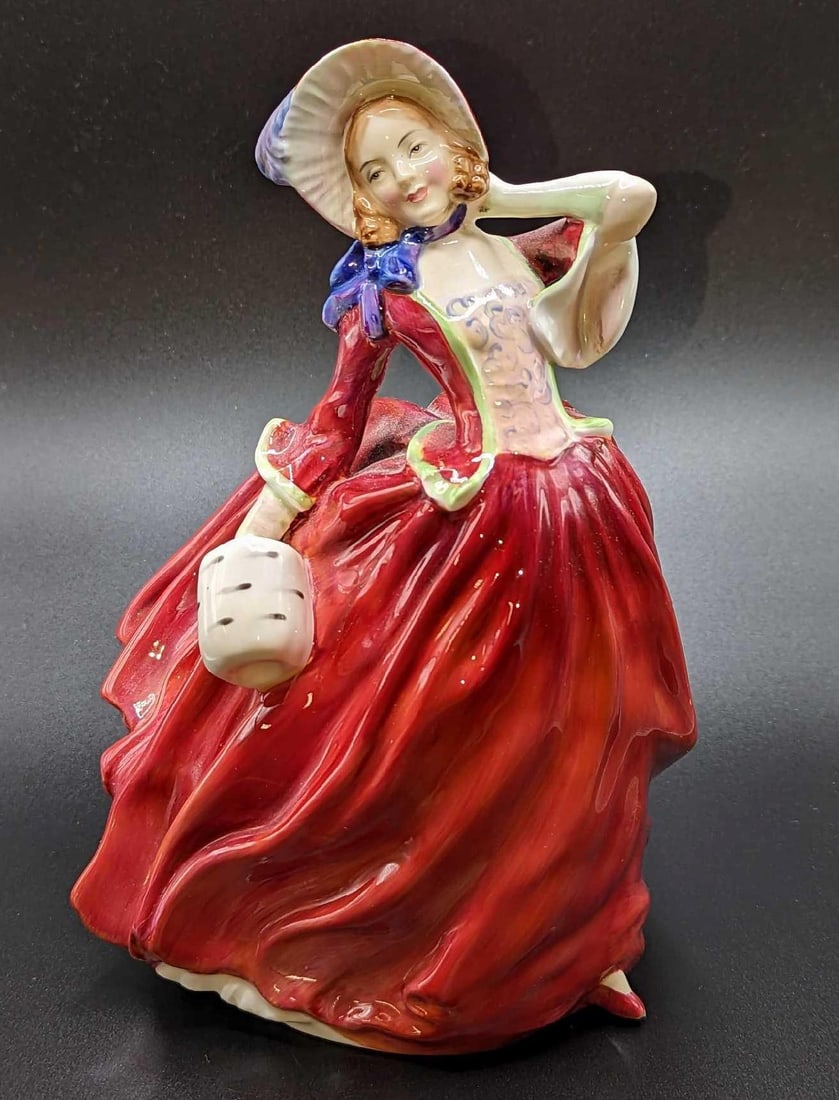 Vintage Retired Royal Doulton Autumn Breezes Figurine: Vintage Retired Royal Doulton Autumn Breezes Figurine. This figurine is approximately 5 1/2" x 5" x 7 1/2" and it weighs 1.05lb. The figurine has cracks on the back and on the bottom. Please see the i