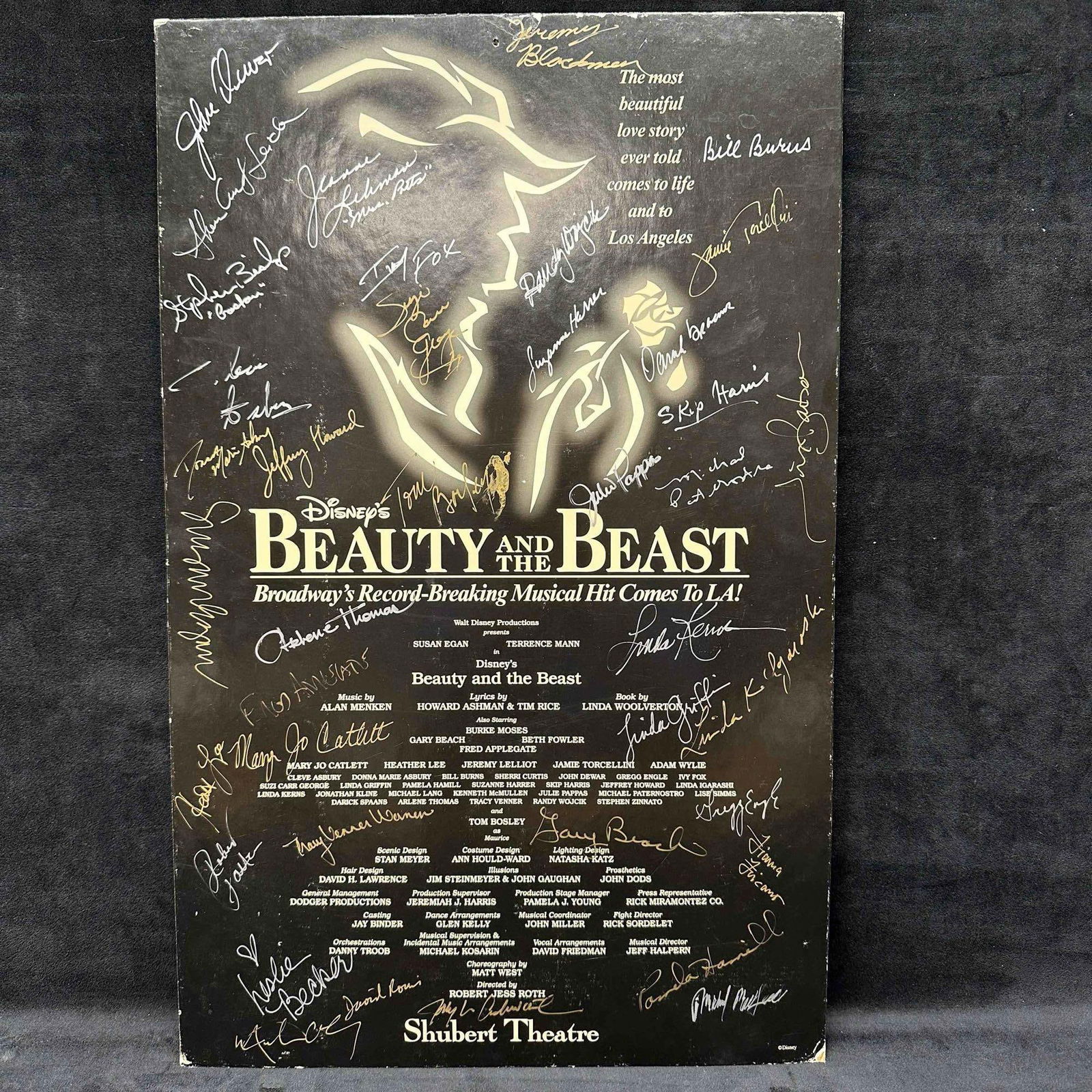 Disney’s Beauty And The Beast Broadway’s Musical Cast Signed Autographed Poster Card Shu: This rectangular cardboard display sign originally used as a promo ad board announcing Disney's Broadway production of Beauty and the Beast coming to Los Angeles. Across the dark background are do