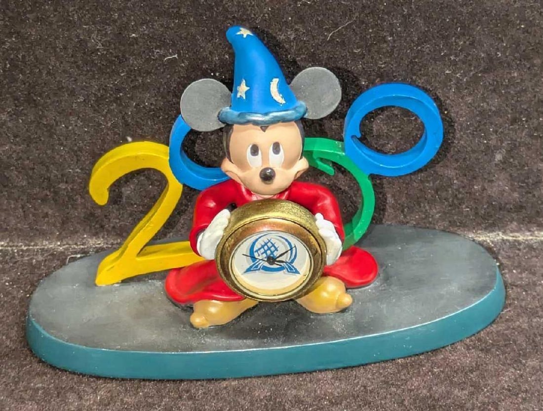 Disney Cast Member Exclusive 1999 Sorcerer Mickey Clock: Disney Cast Member Exclusive 1999 Sorcerer Mickey Clock. It comes in the original box that is approx 6 1/4" x 3"x 4 3/4" and it weighs 0.39lb. The clock has some tarnish and needs a new battery.