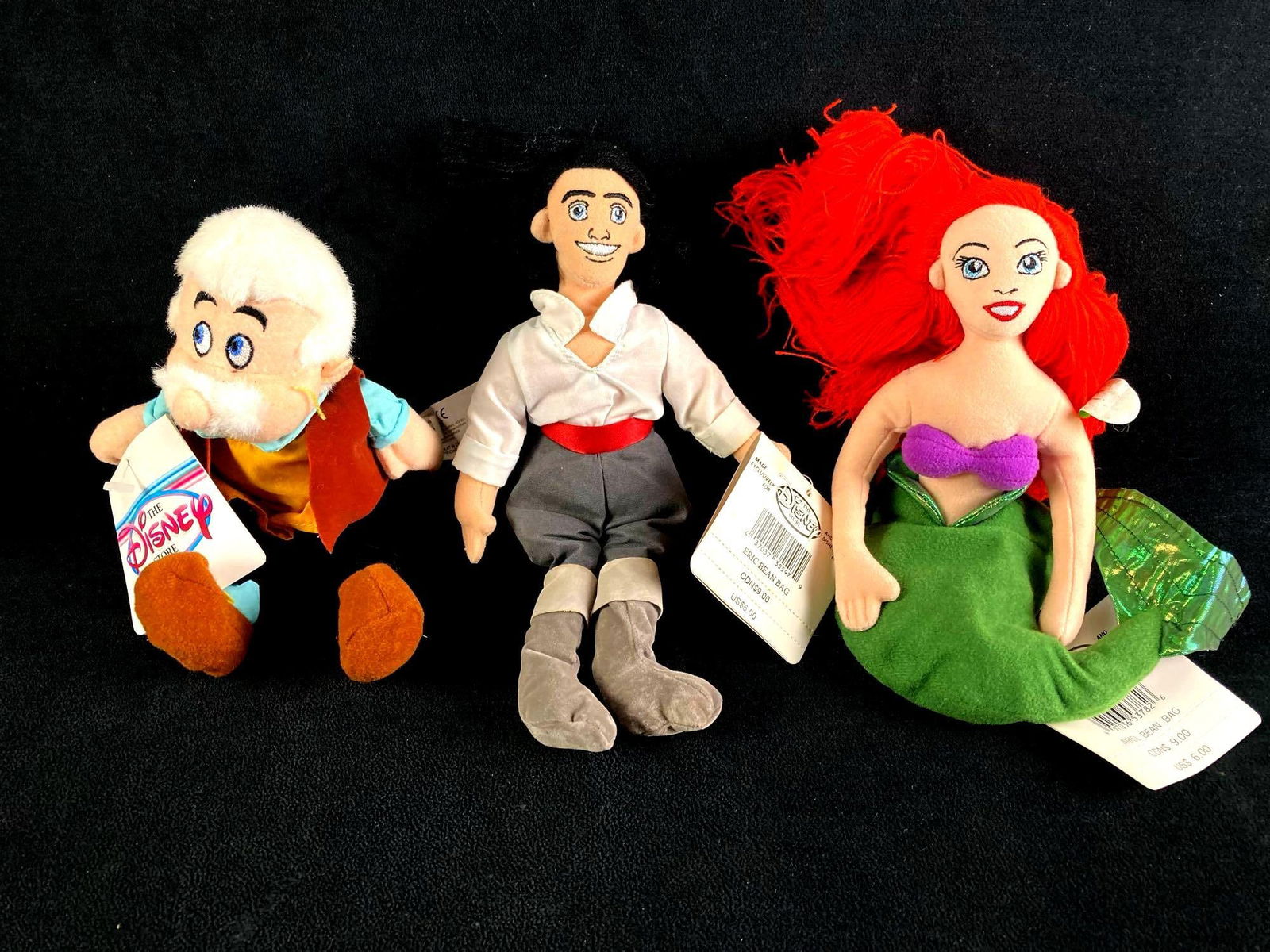 Set of (3) Disney Bean Bag Dolls Eric, Ariel, and Geppetto: This lot includes: (1) Disney Ariel Bean Bag Doll (1) Disney Eric Bean Bag Doll (1) Disney Geppetto Bean Bag Doll Condition is used and refer to photographs for additional details. The