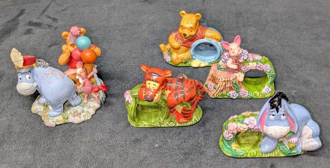 Disney Winnie The Pooh Napkin Ring Set And Figurine: Disney Winnie The Pooh Napkin Ring Set And Figurine. This lot includes: (4) Different Ceramic Winnie The Pooh Napkin Holders. Each is approx 3 1/4" x 3 5/8" x 1 3/4". Some have small
