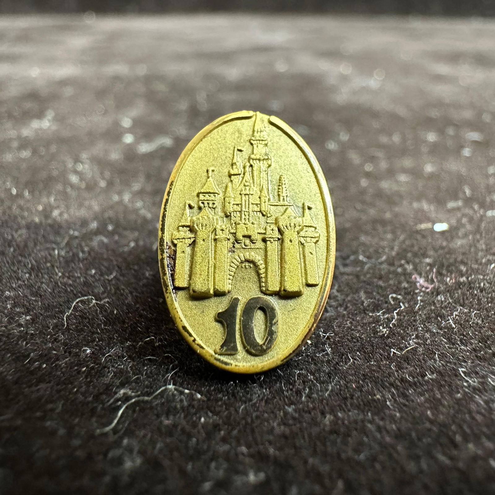 Walt Disney World 10 Year Cinderella Castle Cast Member Service Award Pin: This pin is presented to the Cast Member by Disney when they reach 10 years of service (employment) on or around the anniversary of their date of hire and features Cinderella Castle. The pin is worn