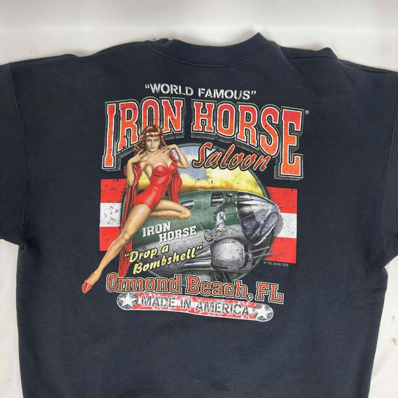 Iron Horse Saloon Black Sweater: Iron Horse Saloon Black Sweater. World famous Iron Horse Saloon "Drop a Bombshell" red dress pin up girl Ormond Beach, FL black sweater. Light thread pulling and small stains. This item is in