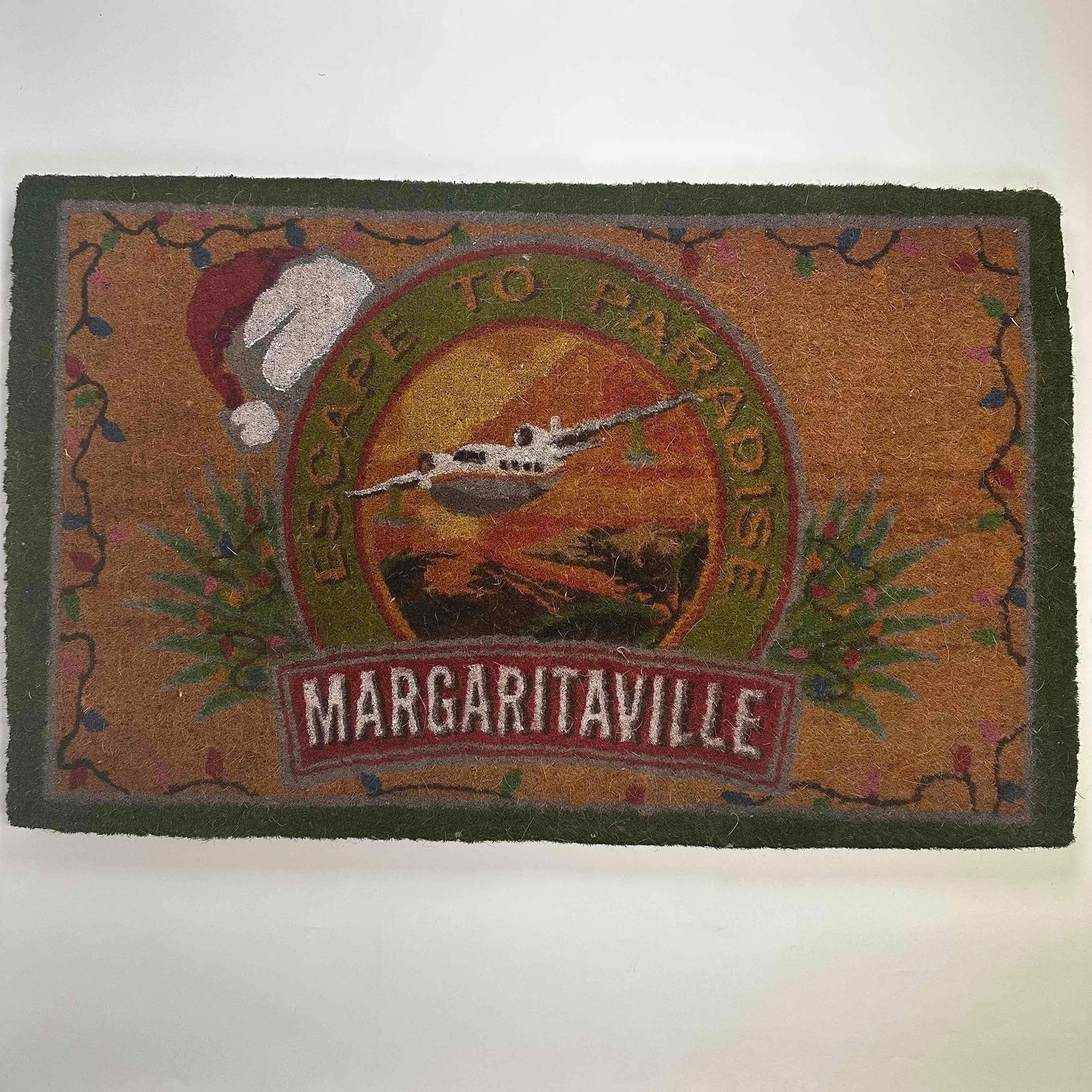 Margaritaville Escape To Paradise Christmas Logo Outdoor Doormat Coco Mat: 100% Coir, also known as coco or coconut coir, is a natural fiber extracted from the fibrous husk of coconuts. Natural fibers outdoor 30 in x 48 in Margaritaville Christmas mat made in India.
