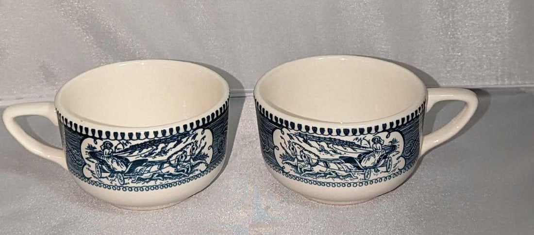 2 Currier and Ives China Cups Star Of The Road: 2 Currier and Ives China Cups Star Of The Road. Each cup is approx 5" x 3 5/8" and together they weigh 1lb. The cups are in a good, vintage condition with some wear on the bottom. Made in the USA.