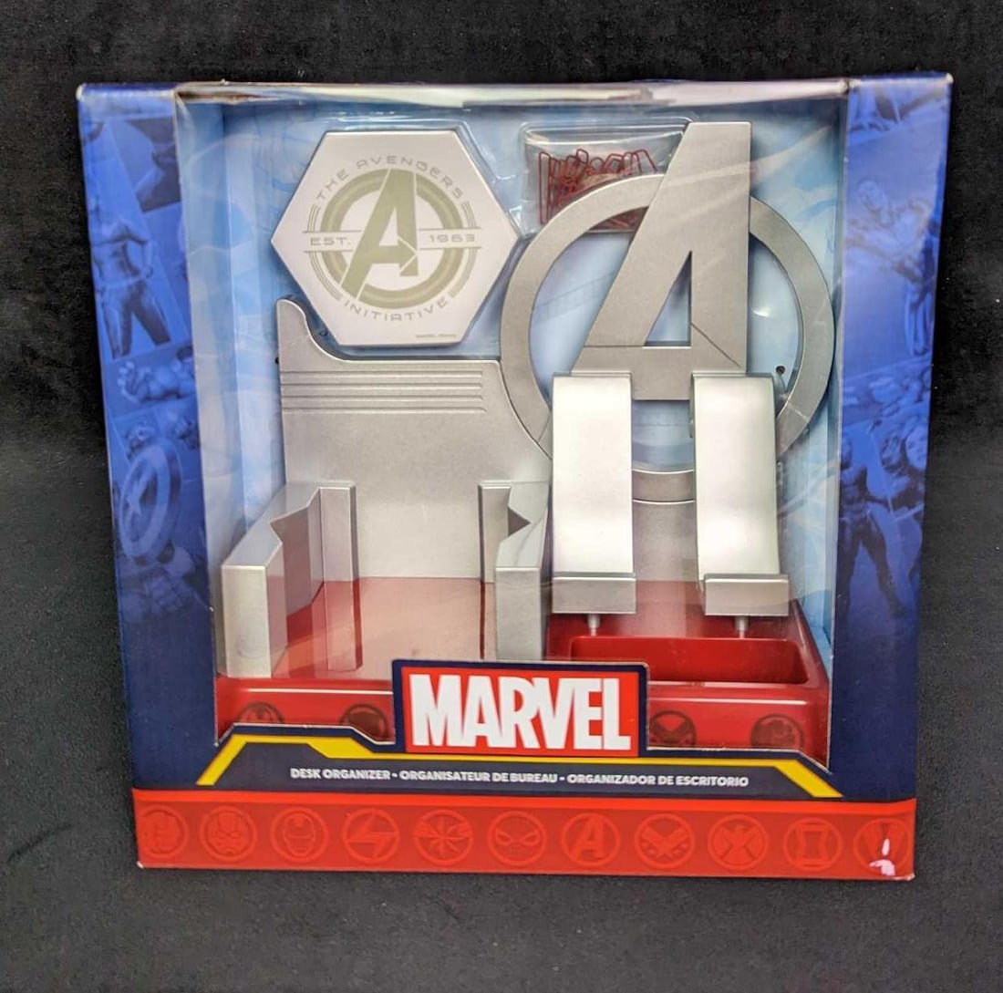 Marvel's Avengers Desk Organizer Set: Marvel's Avengers Desk Organizer Set. This metal design incorporates the Avengers' iconic 'A' symbol and includes a phone stand, sticky notes (and sticky note holder) , and paper clips (and