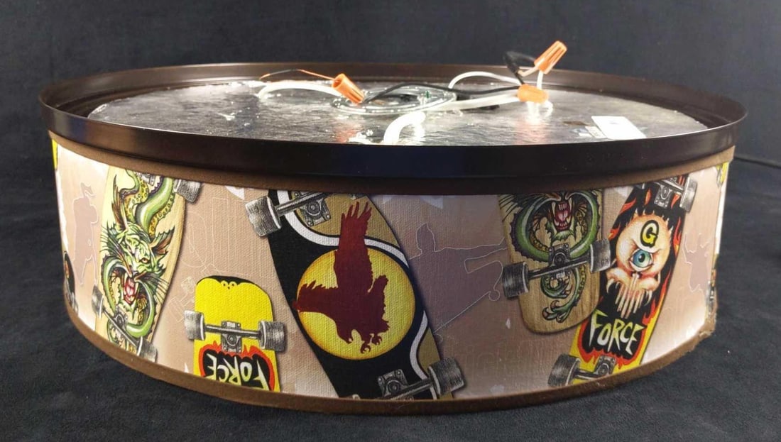 Hanging Kids Skateboard Art Light With Extra Shade: Here is a rather unique hanging lamp with cool skateboard art on its shade. If skateboards are not your thing, it also comes with a more conservative blue and green striped shade that can