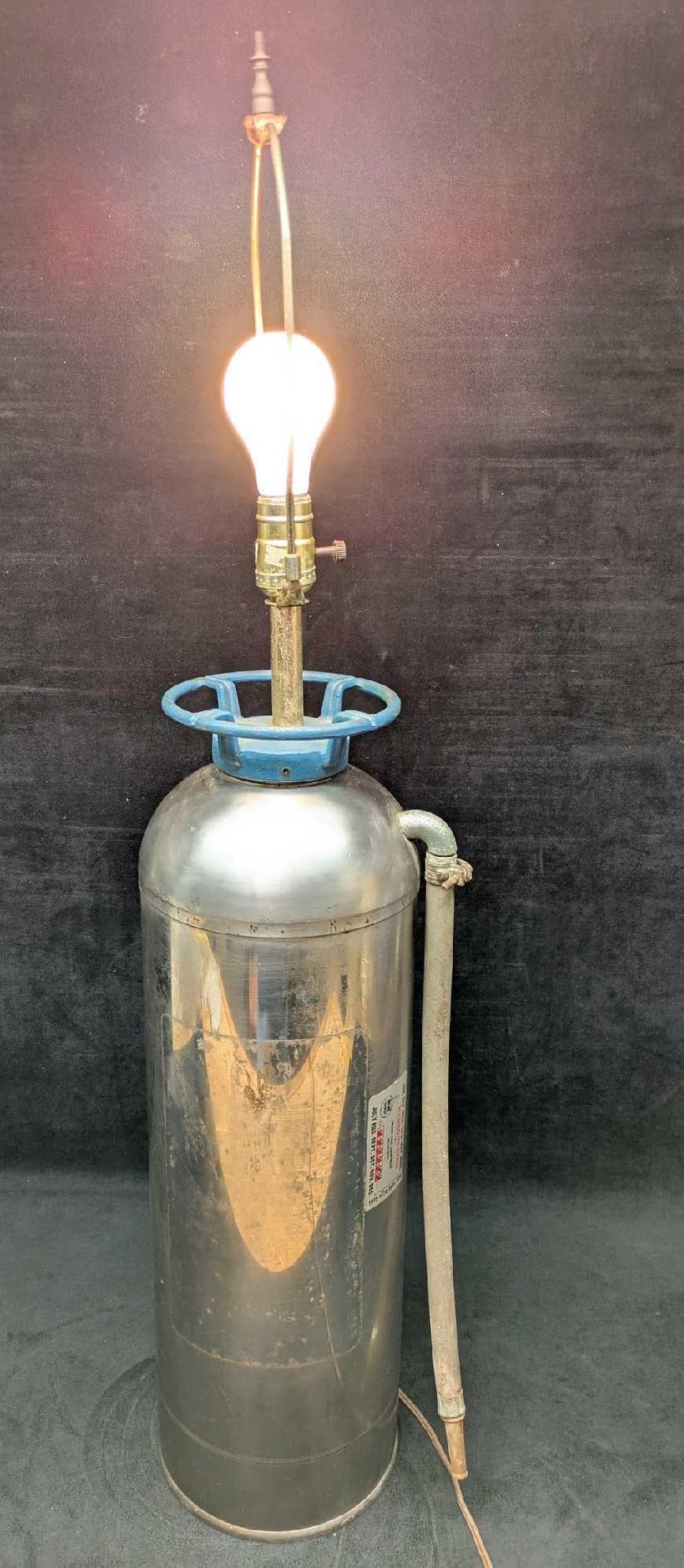 Vintage Converted Fire Extinguisher Table Lamp: Vintage Converted Fire Extinguisher Table Lamp. Here is an vintage metal fire extinguisher that had been converted into a lamp. The lamp is approx 8" x 7" x 36". Without the harp and bulb, it's
