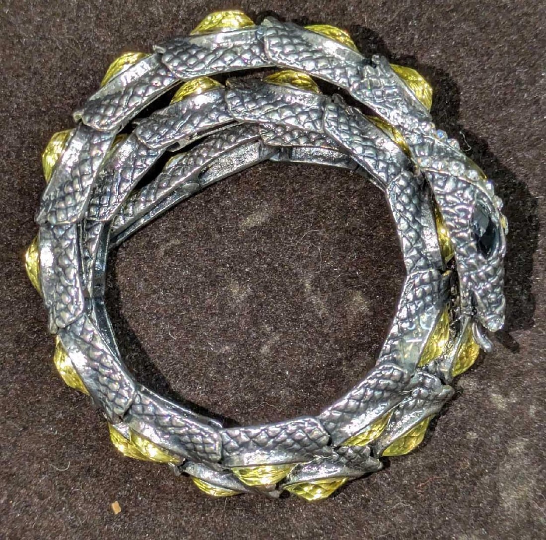 Vintage Silver Tone Serpent Bracelet: Vintage Silver Tone Serpent Bracelet. Has oval cabochon and round canary yellow main stones.This is approx 3" x 1" x 3" and it weighs 0.18lb. The maker and date of creation is unknown.