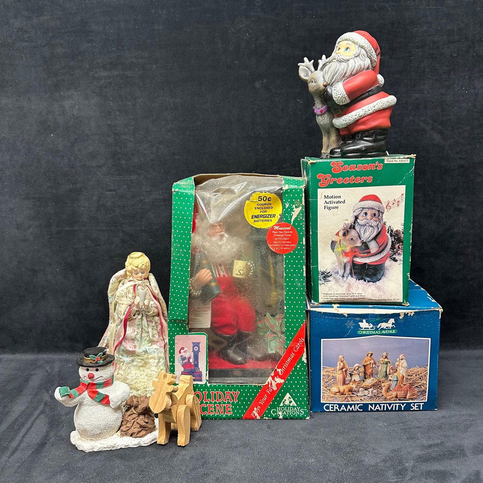 Holiday Christmas Decorations Nativity Set Musical Santa and Figurines: An assorted group of vintage Christmas holiday decorations. The lot includes a Christmas Avenue ceramic nativity set with multiple figures in the original box, a Season’s Greetings motion-activated