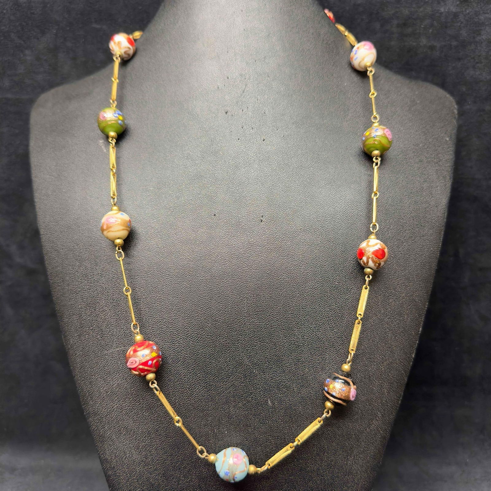 Murano Venetian Art Glass Lamp Work Bead Multi Colored Beaded Chain Necklace C11: Murano Venetian Art Glass Lamp Work Bead Multi Colored Beaded Chain Necklace C11. Necklace with multi colored glass beads with beautiful designs on each. The necklace features floral and copper colore