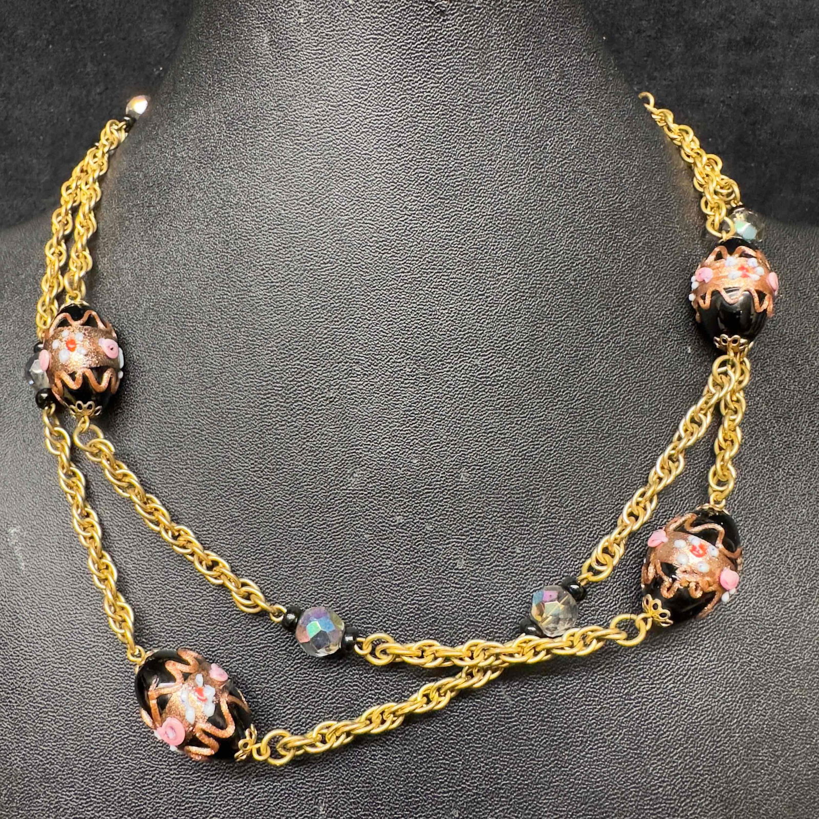 Murano Venetian Lamp Work Glass Black Bead Fiorato Beaded Pendant Necklace A66: Murano Venetian Lamp Work Glass Black Bead Fiorato Beaded Pendant Necklace A66. Necklace with black colored glass beads with beautiful hand painted designs on each. The necklace features copper accent