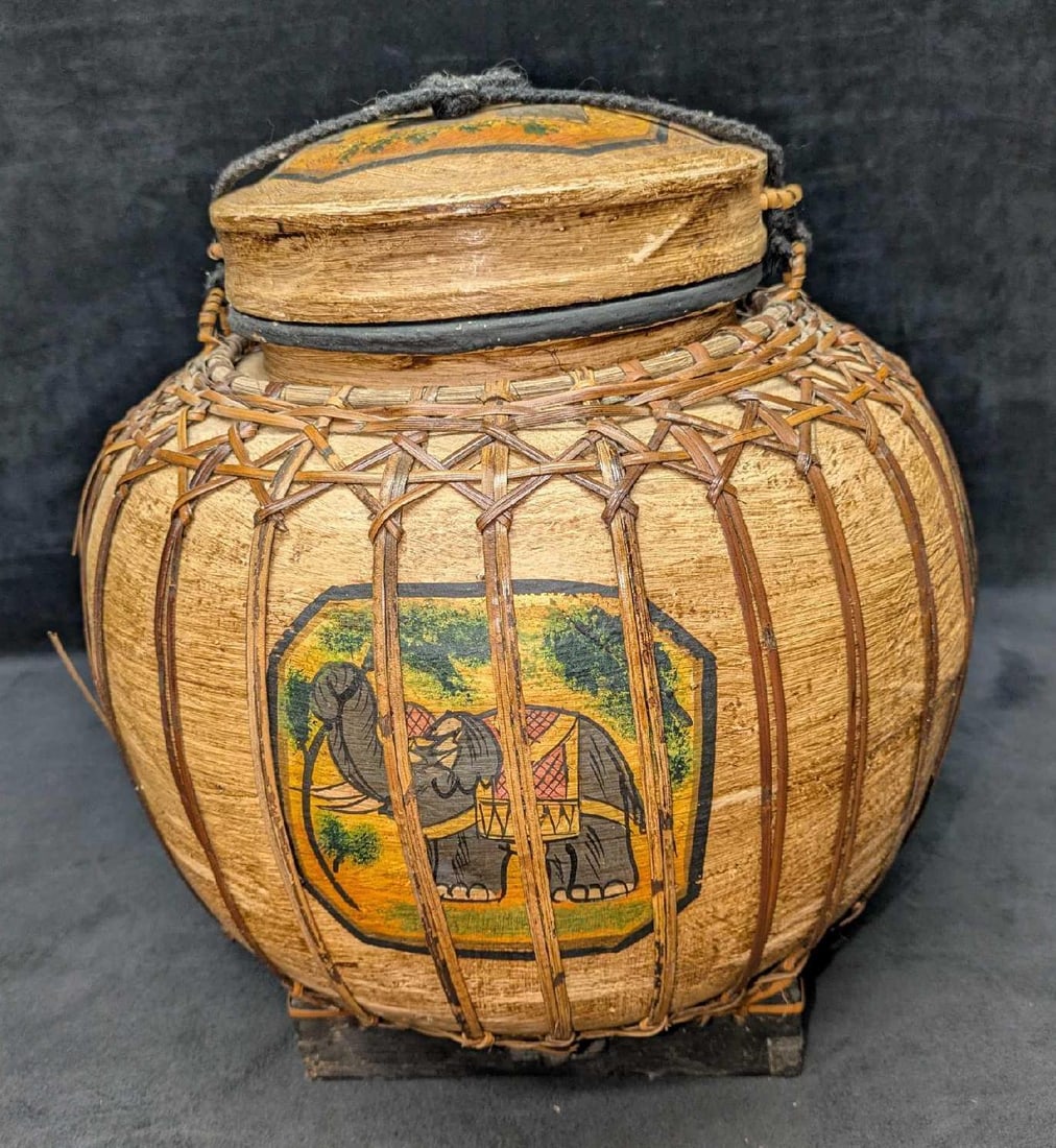 Vintage Hand Painted Wooden And Woven Bamboo Lucky Elephant Rice Jar: Vintage Hand Painted Wooden And Woven Bamboo Lucky Elephant Rice Jar. The maker and date of creation is unknown. This is approx 13" x 12" x 12" and it weighs 2.70lbs. Some of the straps have snapped