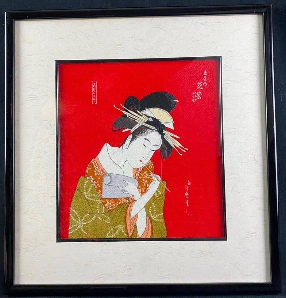 Japanese Print on Textured Silk: Japanese Print on Textured Silk This Japanese print in a style reminiscent of the traditional woodblocks shows a woman applying lip paint with a bamboo brush. The piece is professionally framed,