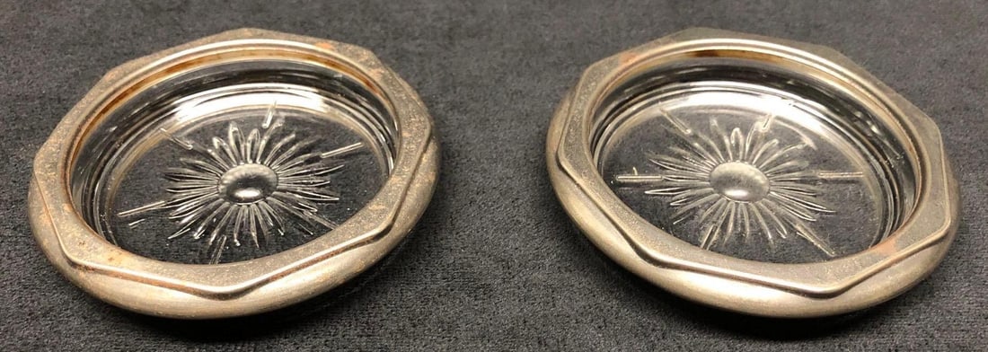 Pair Vintage MCM Clear Cut Glass Silver Plate Coasters: This lot contains Pair of Vintage MCM Clear Cut Glass Silver Plate Coasters. Each coaster is approx 4" x 4" x 3/4" with a combined weight of about 0.5lbs. Overall the Vintage MCM Coasters
