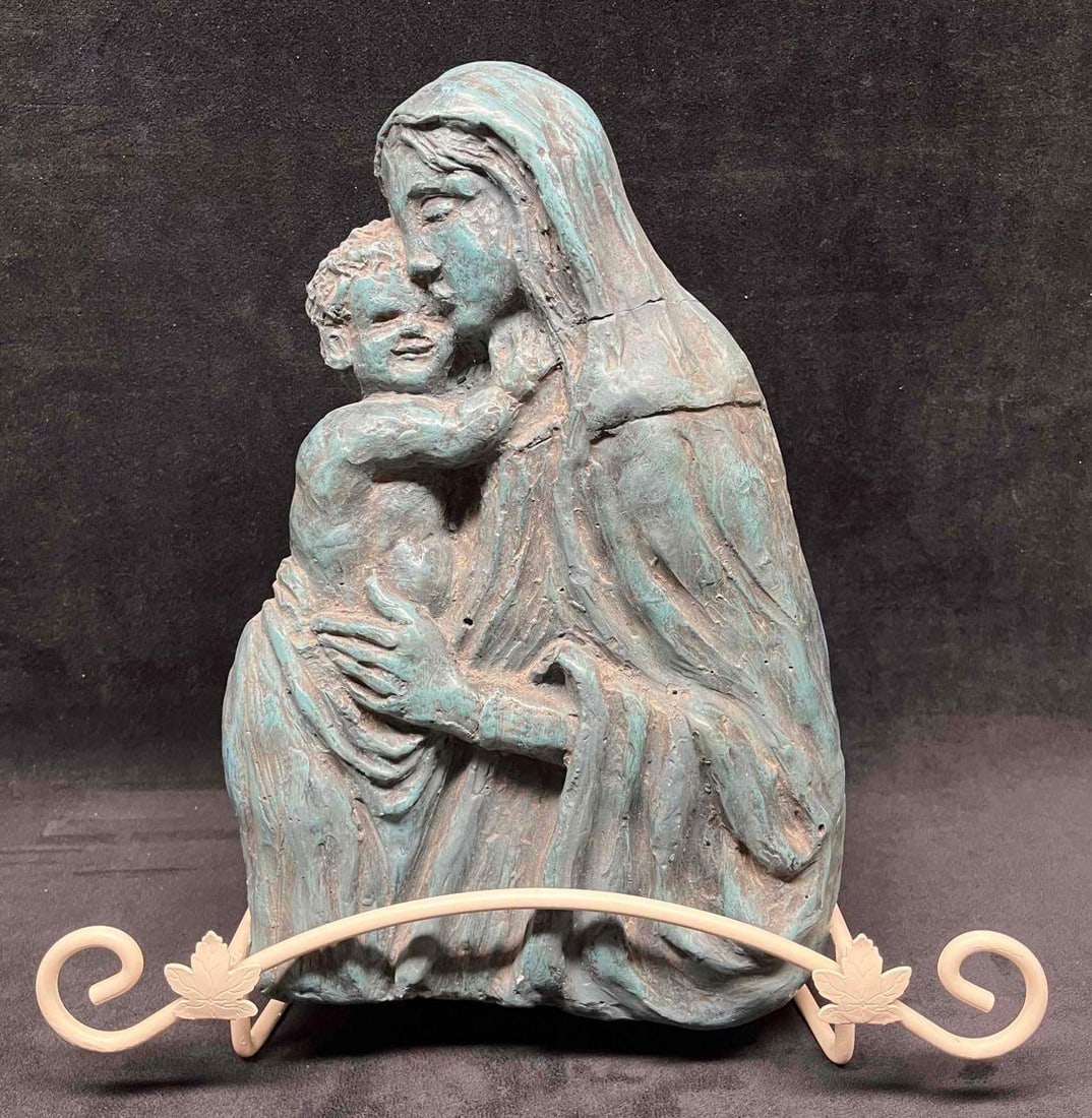 Carved Religious Pottery Sculpture & Stand Virgin Mary & Baby Jesus: This lot contains a Carved Religious Pottery Sculpture & Stand Virgin Mary & Baby Jesus. The stand is approx 13" x 7 1/2" x 9 1/4" while the artwork is approx 8" x 2" x 12 3/4". Together the stand and