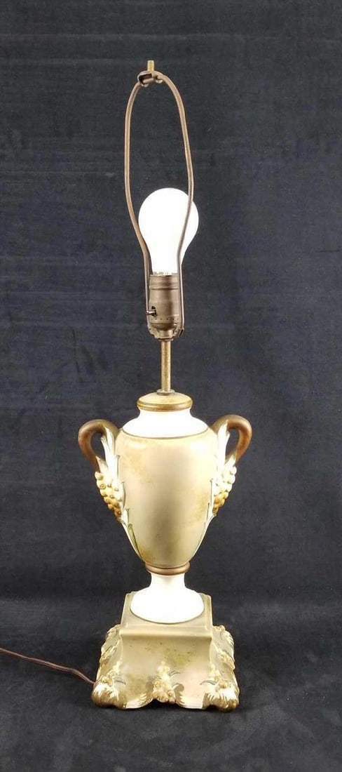 Vintage Green and White Ceramic Table Lamp: This table lamp is ceramic with a green primary color and white and brown trim. There is a floral pattern. The lamp manufacture is unknown and so is the date. It is corded and works. It is in good