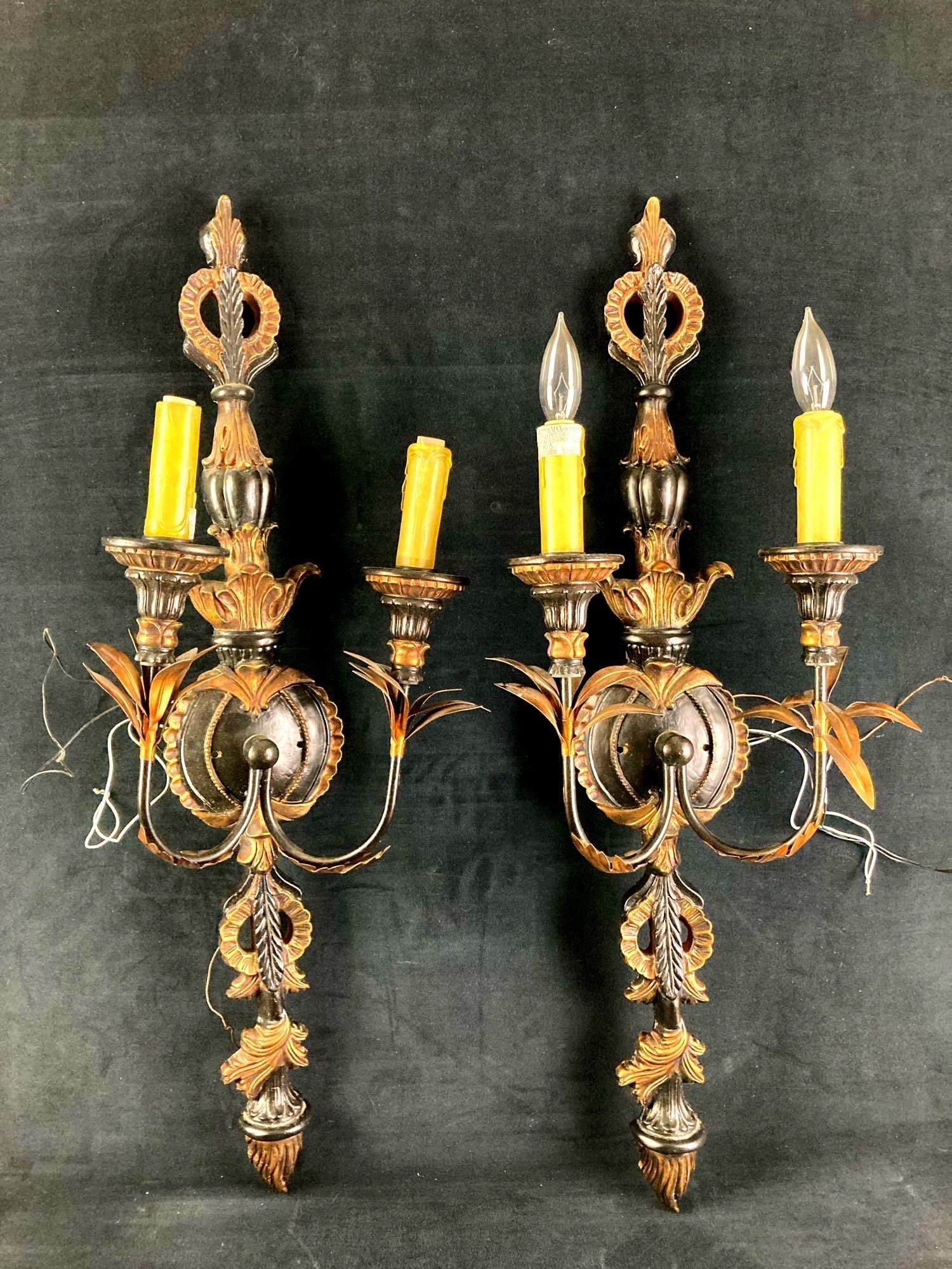 Pair of Wall Mount Incandescent Luminaires Tropical Style: Up for auction is a pair of incandescent luminaire wall mounts made into a tropical style. This pair came from inside a house. The lamps are decorated like a wax candle and the candle holders are in