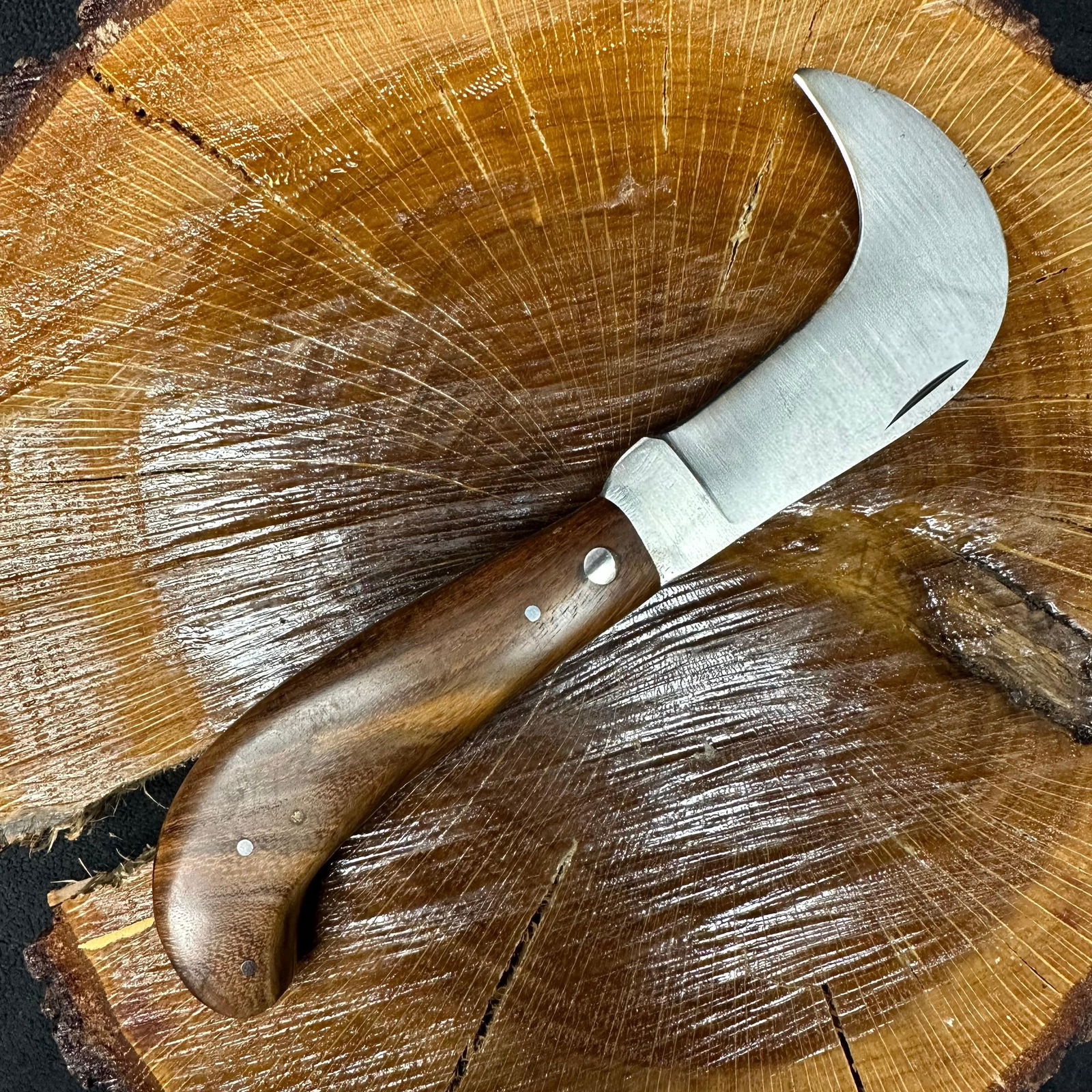 MHS Cutlery Steel Hawkbill Pruning Style Knife Q78: Folding blade pocket knife by MHS Cutlery featuring a stainless steel blade. The handle has a curved, contoured, wood/resin-style grip with metal mosaic pin accents. Hawkbill Pruning style knife. 
